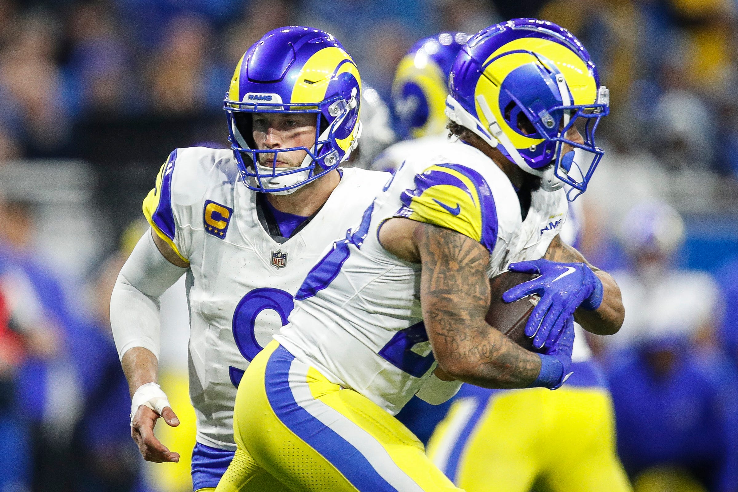 L.A. Rams quarterback Matthew Stafford (9) hands the ball to running back Kyren Williams (23) against the Detroit Lions during the second half of the NFL wild-card playoff game at Ford Field in Detroit on Sunday, Jan, 14, 2024.