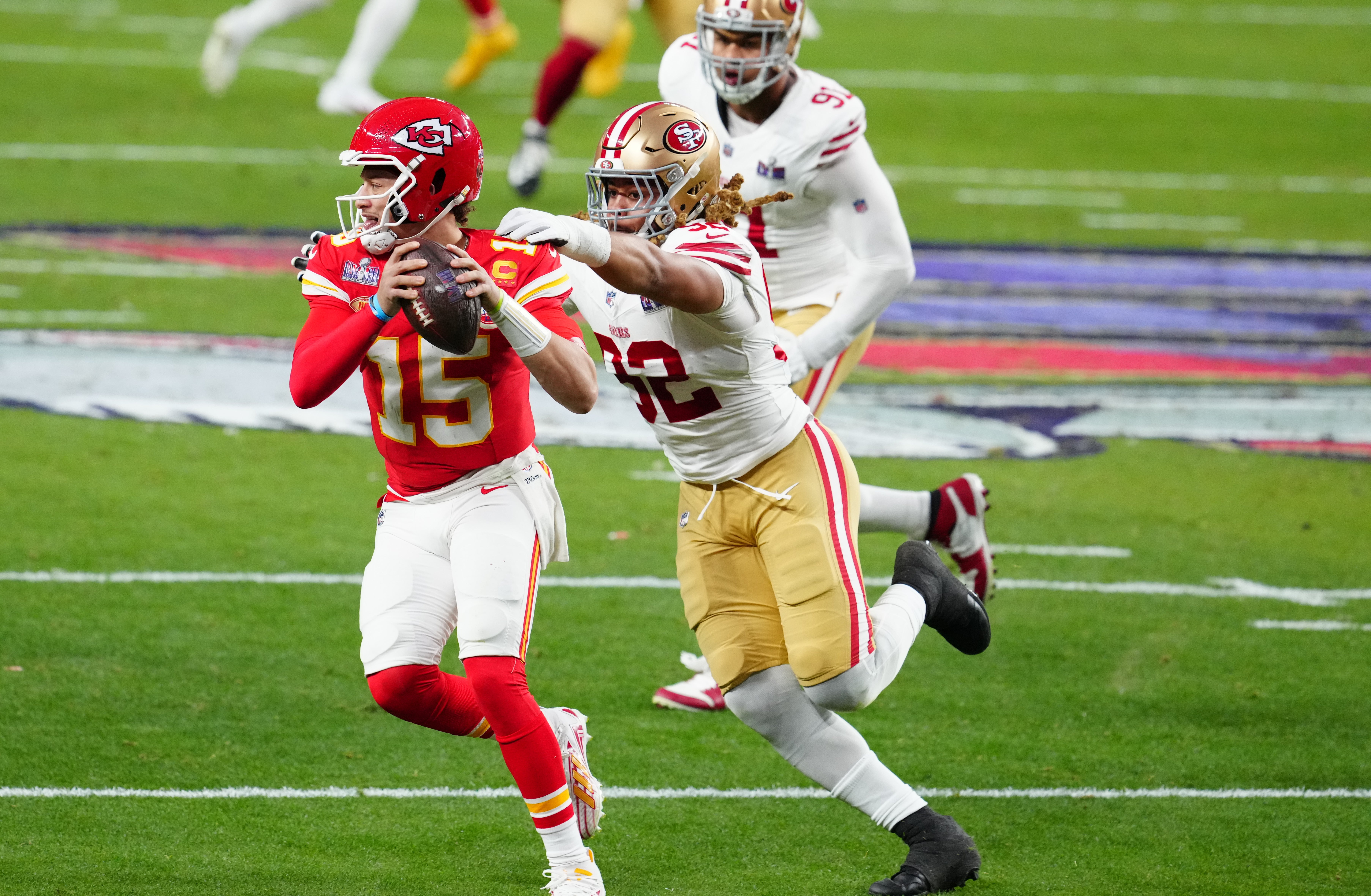 Feb 11, 2024; Paradise, Nevada, USA; Kansas City Chiefs quarterback Patrick Mahomes (15) is pressured by San Francisco 49ers defensive end Chase Young (92) in the first half in Super Bowl LVIII at Allegiant Stadium.