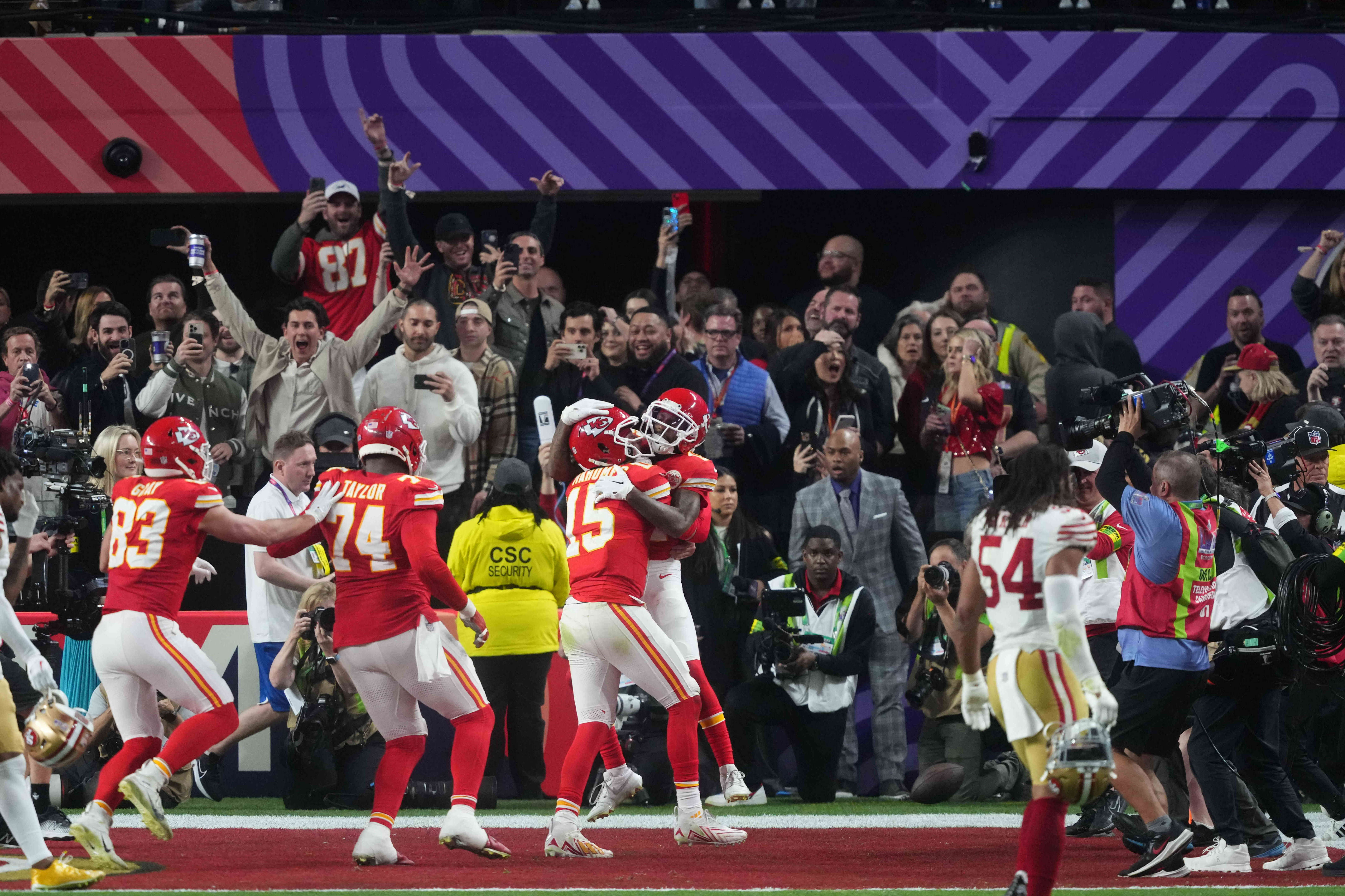 Feb 11, 2024; Paradise, Nevada, USA; Kansas City Chiefs wide receiver Mecole Hardman Jr. (12) celebrates a touchdown with quarterback Patrick Mahomes (15) to win against the San Francisco 49ers during overtime of Super Bowl LVIII at Allegiant Stadium.