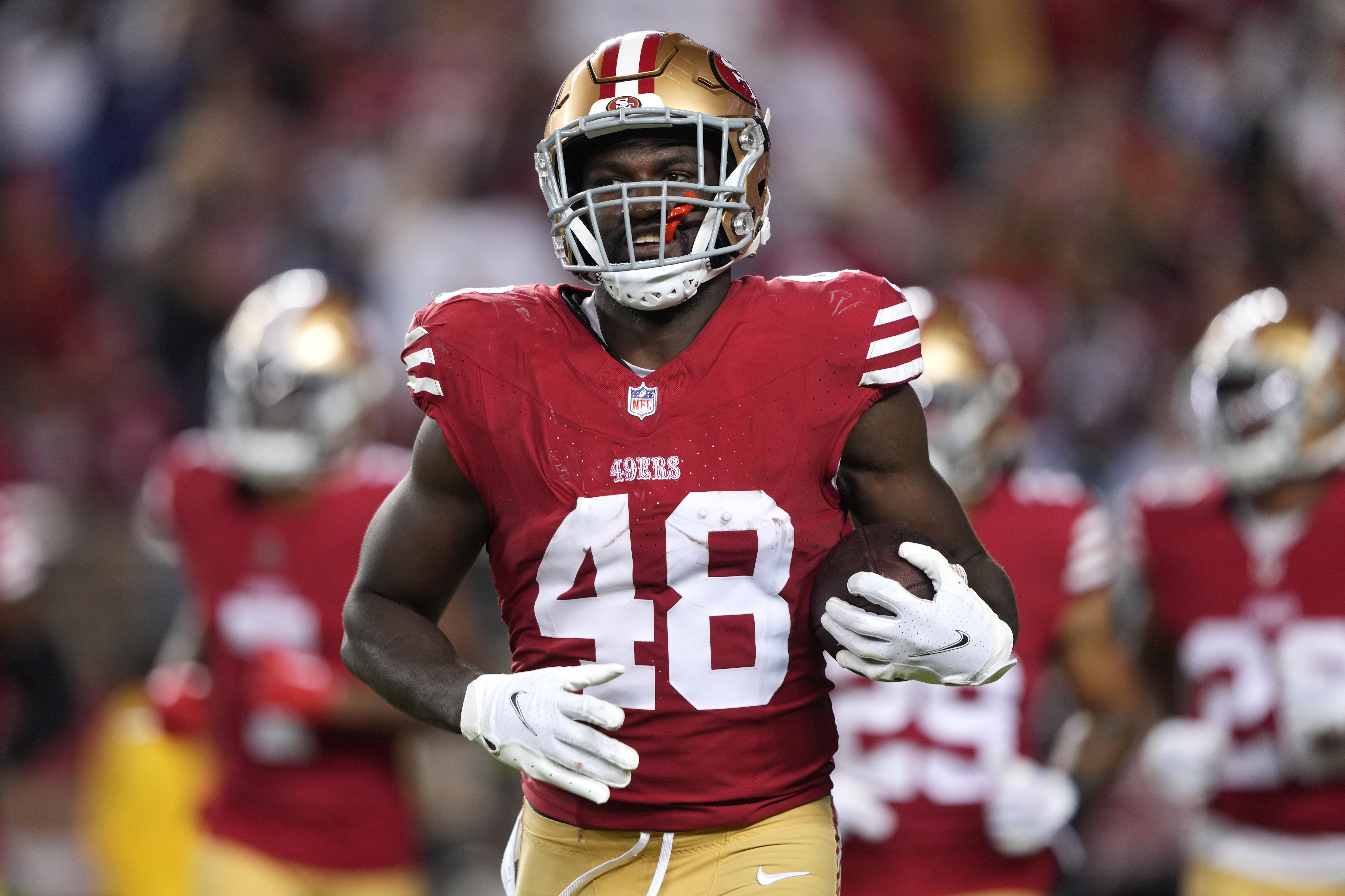 San Francisco 49ers linebacker Oren Burks (48) jogs off of the field with the game ball after an interception against the Dallas Cowboys