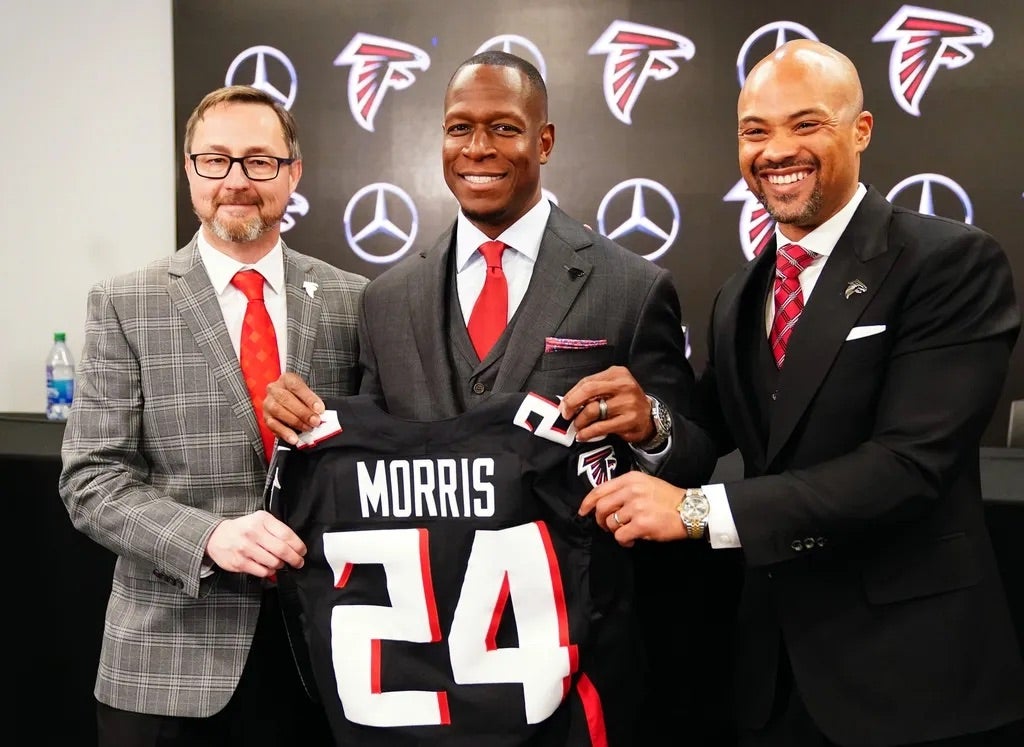 Falcons president Greg Beadles, head coach Raheem Morris and general manager Terry Fontenot of the Atlanta Falcons pose for the media after Morris is introduced as the head coach of the Atlanta Falcons.