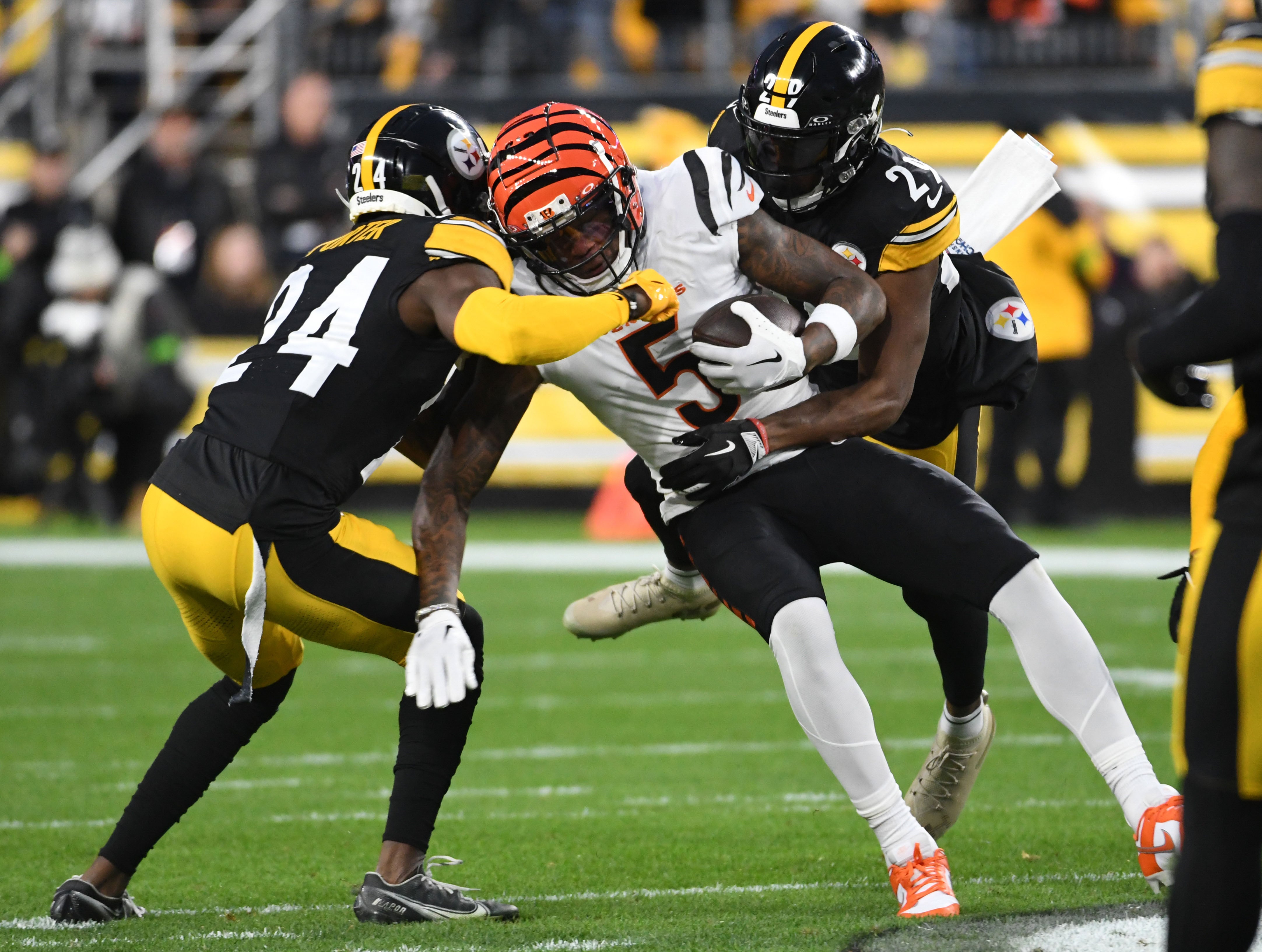 Dec 23, 2023; Pittsburgh, Pennsylvania, USA; Pittsburgh Steelers cornerbacks Joey Porter, Jr. (24) and Levi Wallace (29) take down Cincinnati Bengals wide receiver Tee Higgins (5) at Acrisure Stadium. Mandatory Credit: Philip G. Pavely-USA TODAY Sports
