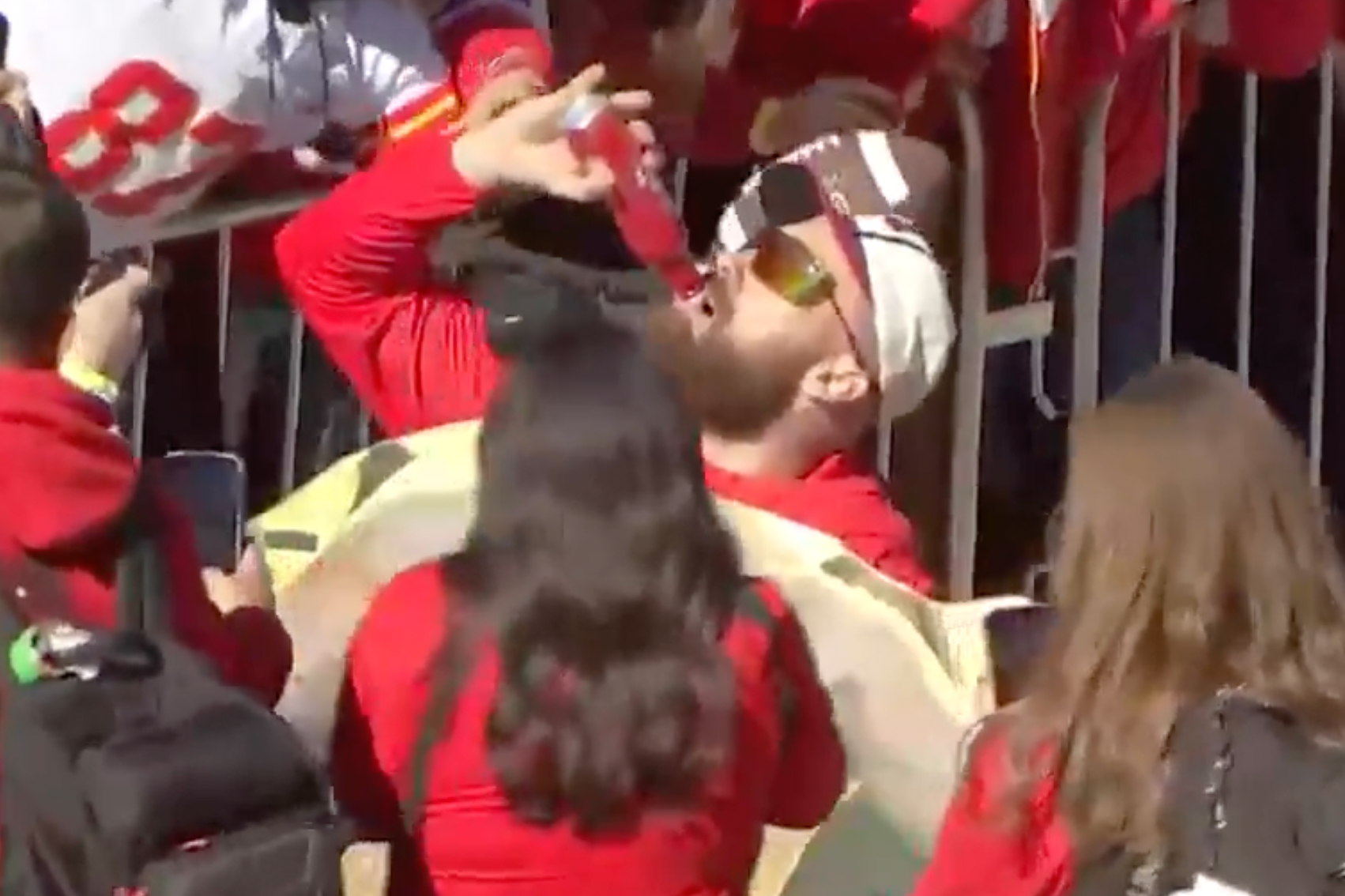 Travis Kelce runs over to fan who has a shirtless Jason Kelce cutout at Chiefs Super Bowl parade