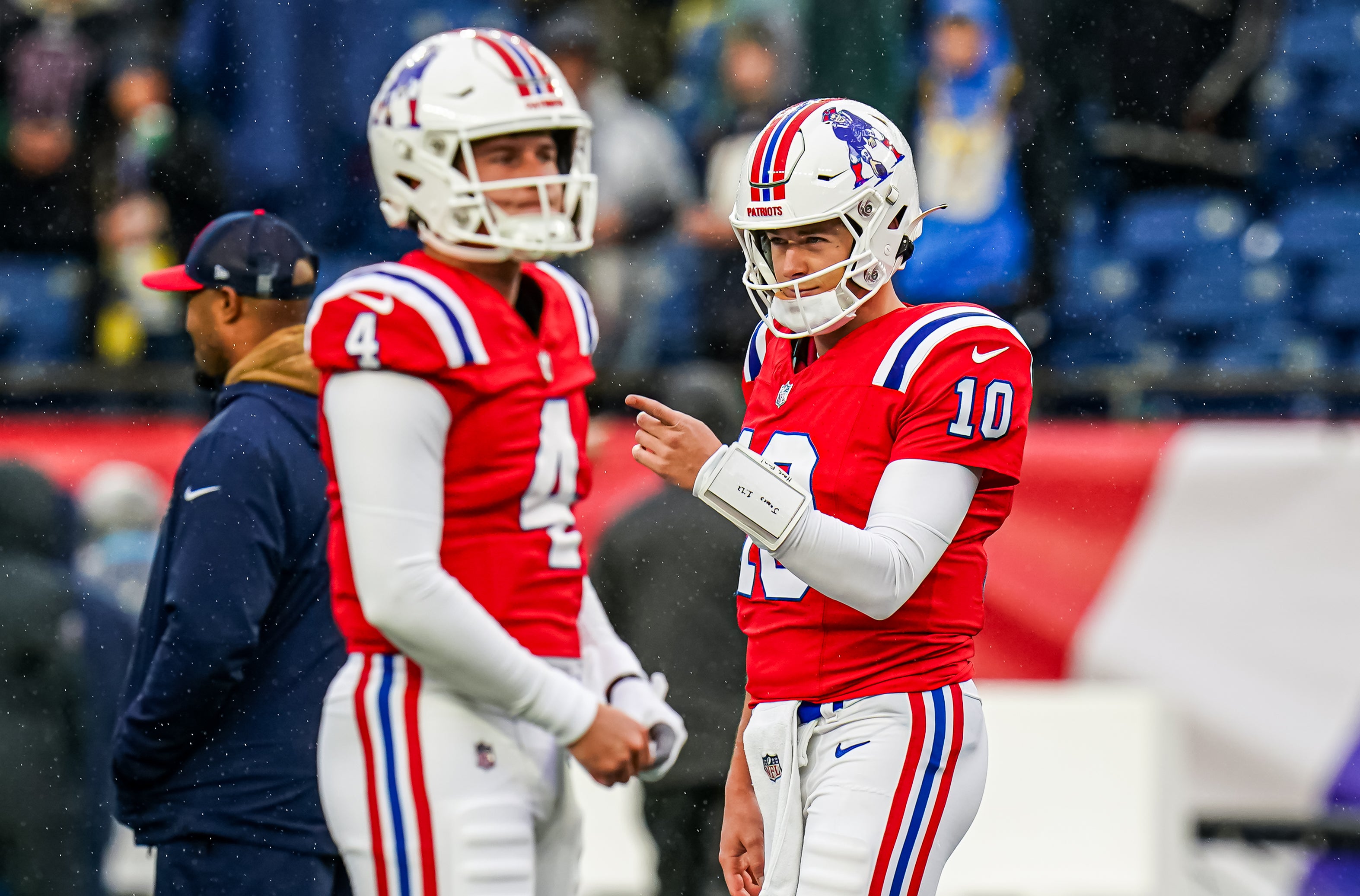 Dec 3, 2023; Foxborough, Massachusetts, USA; New England Patriots quarterback Mac Jones (10) and quarterback Bailey Zappe (4) in the field to warm up before the start of the game against the Los Angeles Chargers at Gillette Stadium.