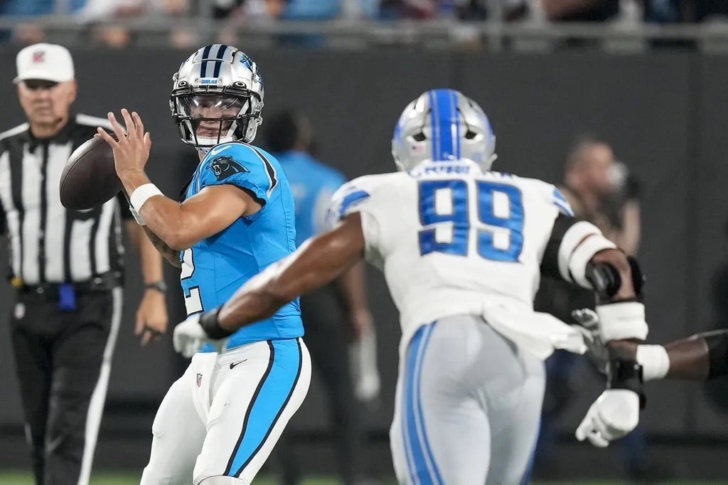 Carolina Panthers quarterback Matt Corral (2) drops back to pass against Detroit Lions linebacker Julian Okwara (99) during the second half at Bank of America Stadium.