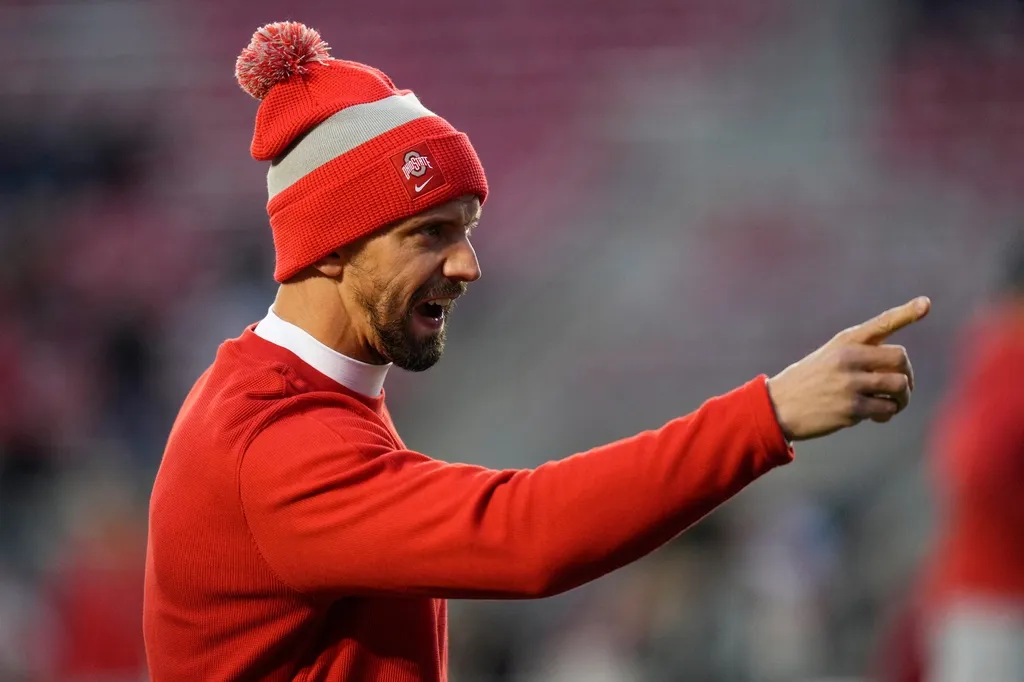 Ohio State Buckeyes assistant coach James Laurinaitis warms up his team prior to the NCAA football game against the Wisconsin Badgers at Camp Randall Stadium.