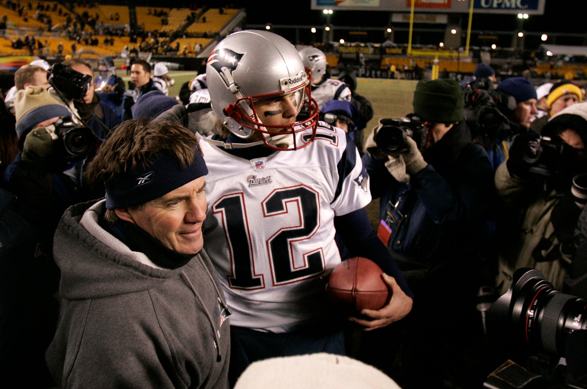 Jan 23, 2005; Pittsburgh, PA, USA; New England Patriots head coach Bill Belichick and quarterback Tom Brady (12) celebrate after winning the 2004 AFC Championship game at Heinz Field. The Patriots beat the Steelers 41-27. 