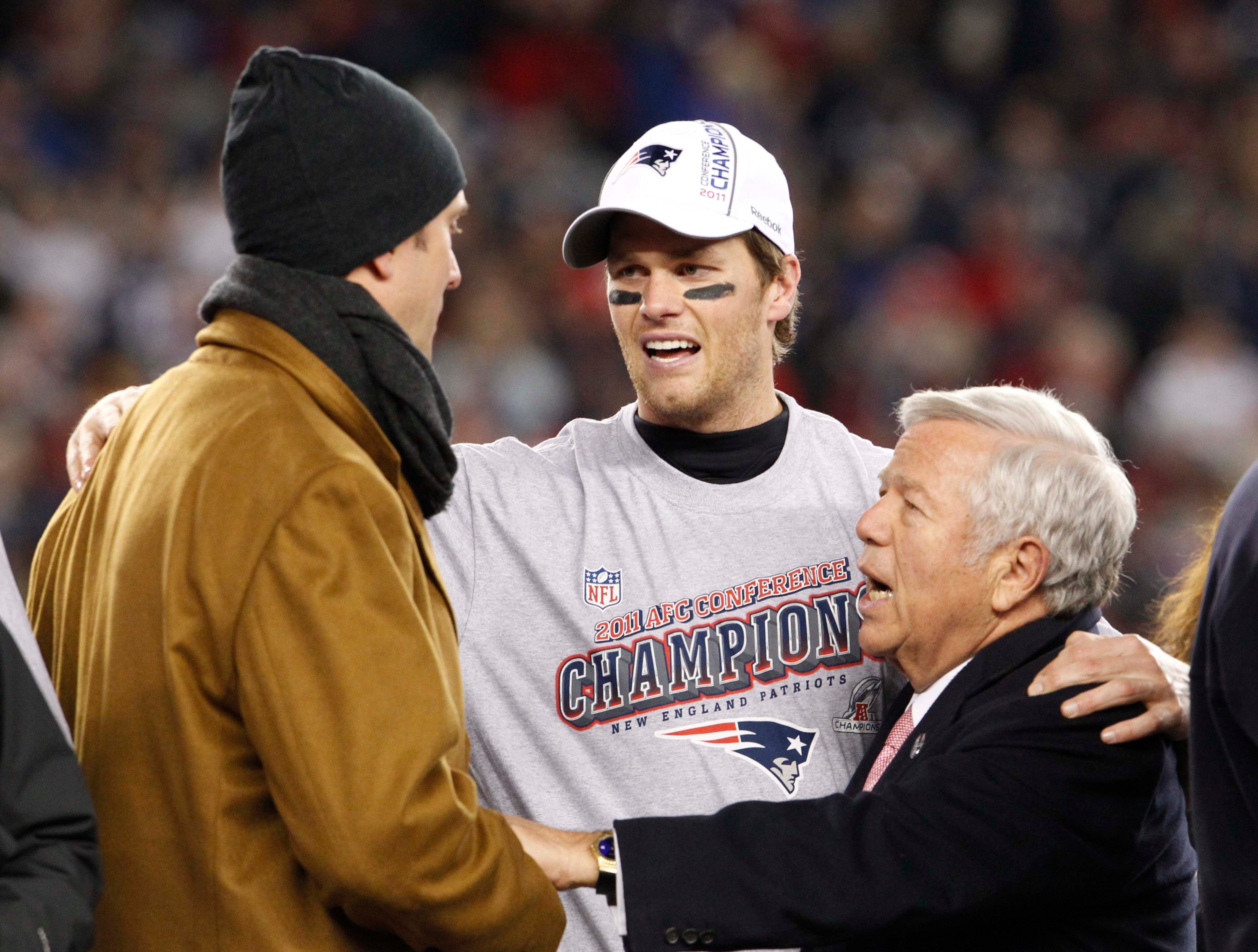 Jan 22, 2012; Foxborough, MA, USA; New England Patriots quarterback Tom Brady (center), owner Robert Kraft (right) and former quarterback Drew Bledsoe (left) talk after the Patriots defeated the Ravens 23-20 in the 2011 AFC Championship game at Gillette Stadium. 