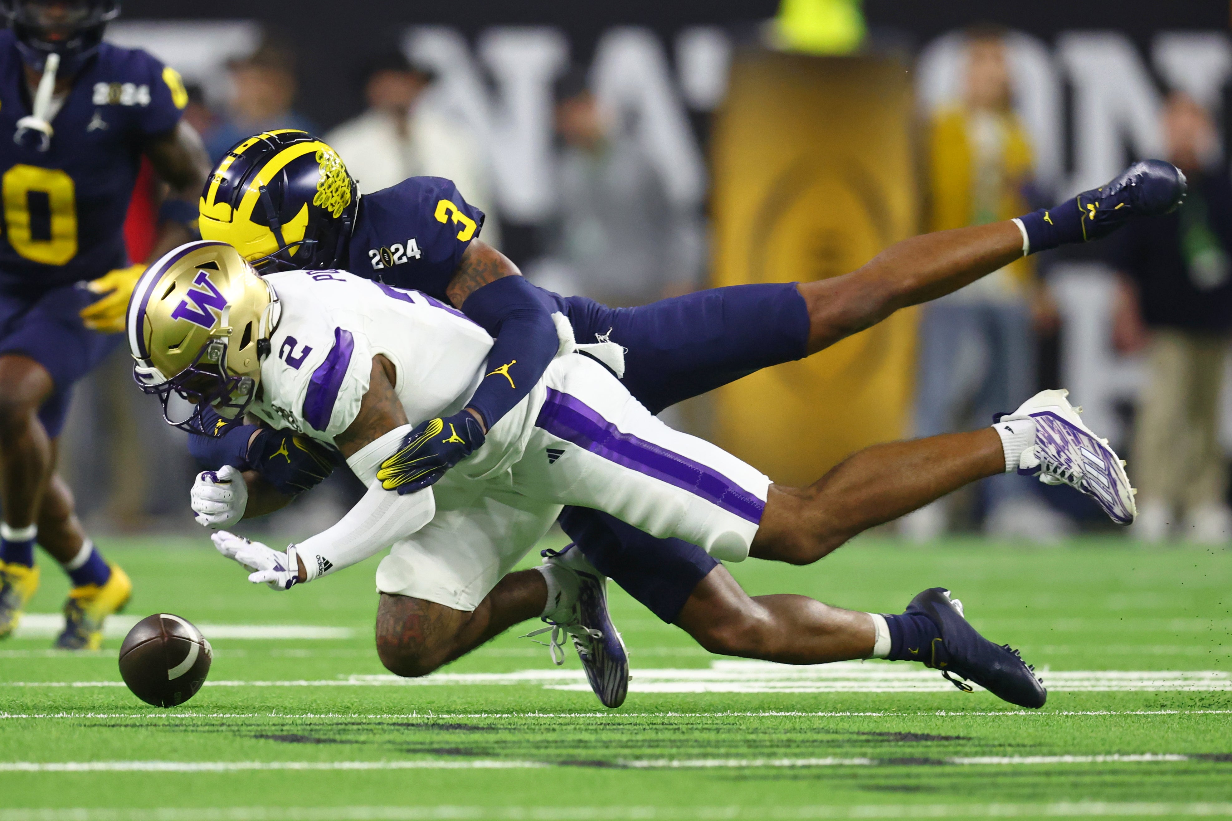 Jan 8, 2024; Houston, TX, USA; Washington Huskies wide receiver Ja'Lynn Polk (2) is unable to make a catch while defended by Michigan Wolverines defensive back Keon Sabb (3) during the fourth quarter in the 2024 College Football Playoff national championship game at NRG Stadium.