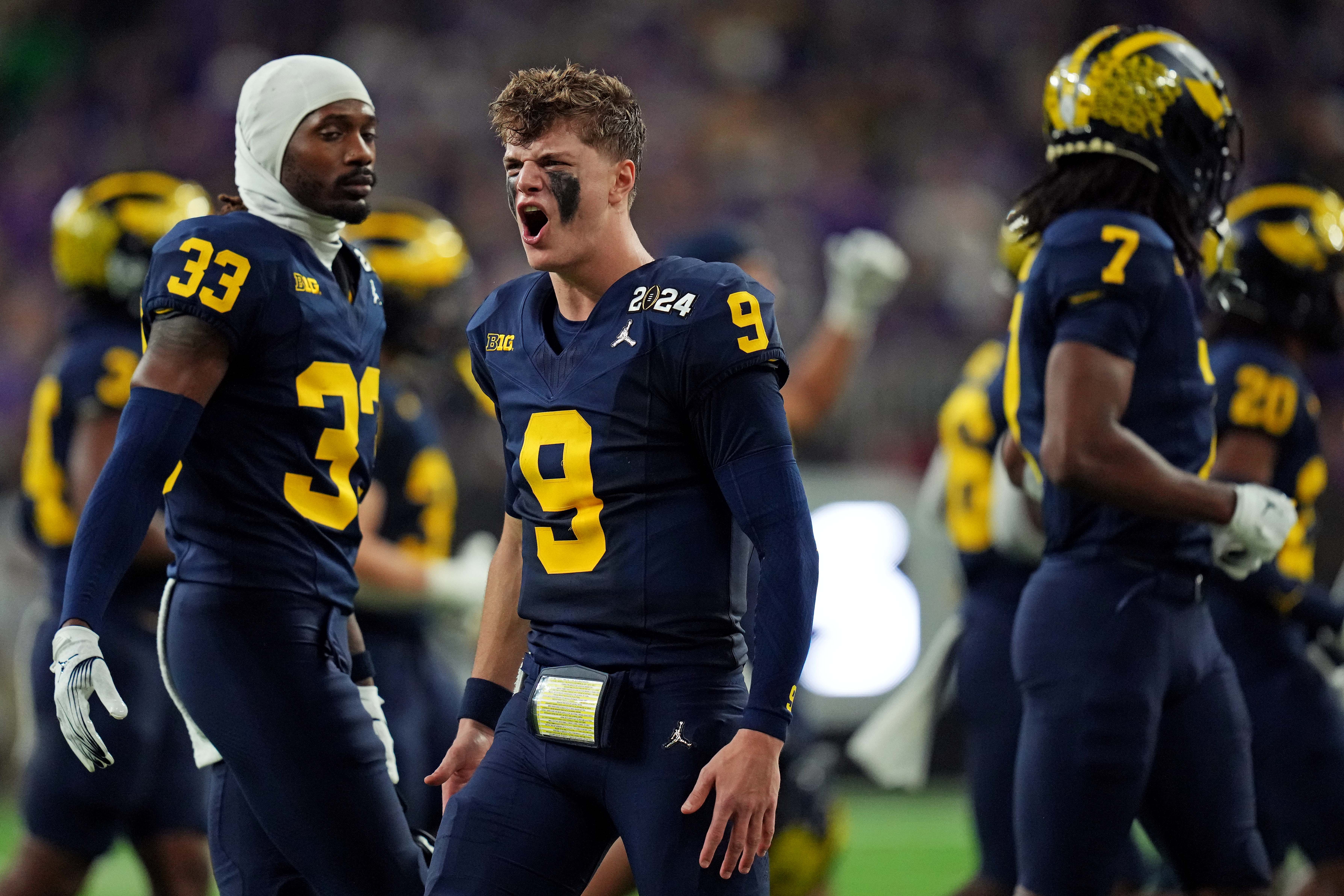 Jan 8, 2024; Houston, TX, USA; Michigan Wolverines quarterback J.J. McCarthy (9) celebrates from the sidelines during the fourth quarter against the Washington Huskies in the 2024 College Football Playoff national championship game at NRG Stadium.