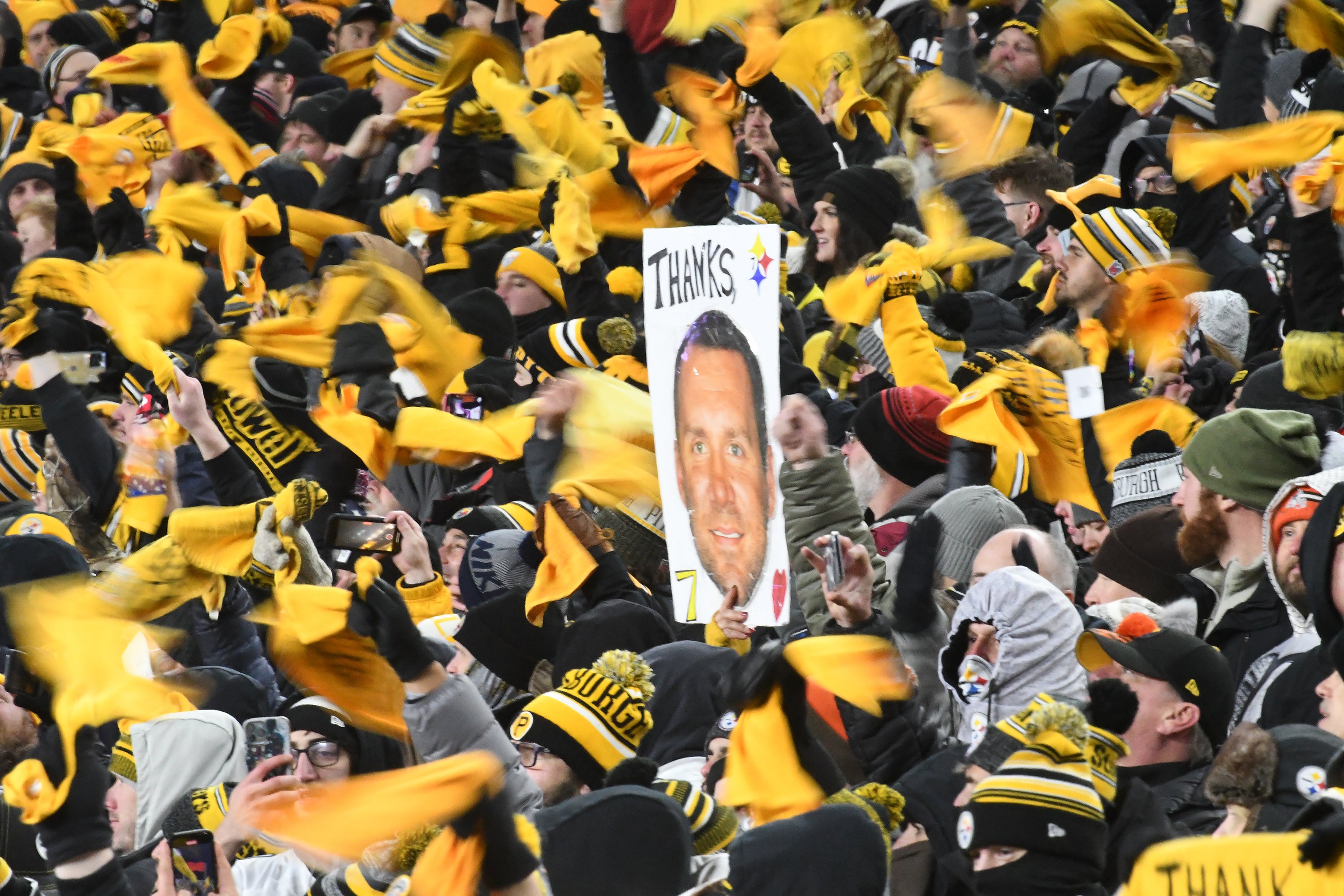 Jan 3, 2022; Pittsburgh, Pennsylvania, USA; Terrible Towels are waved around a sign for Pittsburgh Steelers quarterback Ben Roethlisberger (7) during the game against the Cleveland Browns at Heinz Field. Mandatory Credit: Philip G. Pavely-USA TODAY Sports