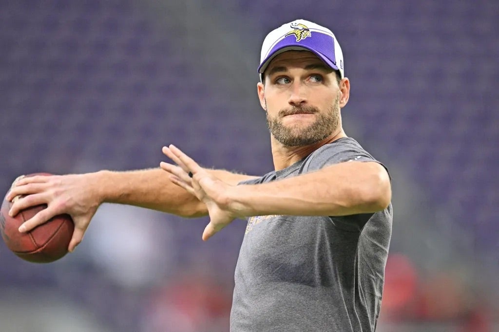 Minnesota Vikings quarterback Kirk Cousins (8) warms up before the game against the San Francisco 49ers at U.S. Bank Stadium.
