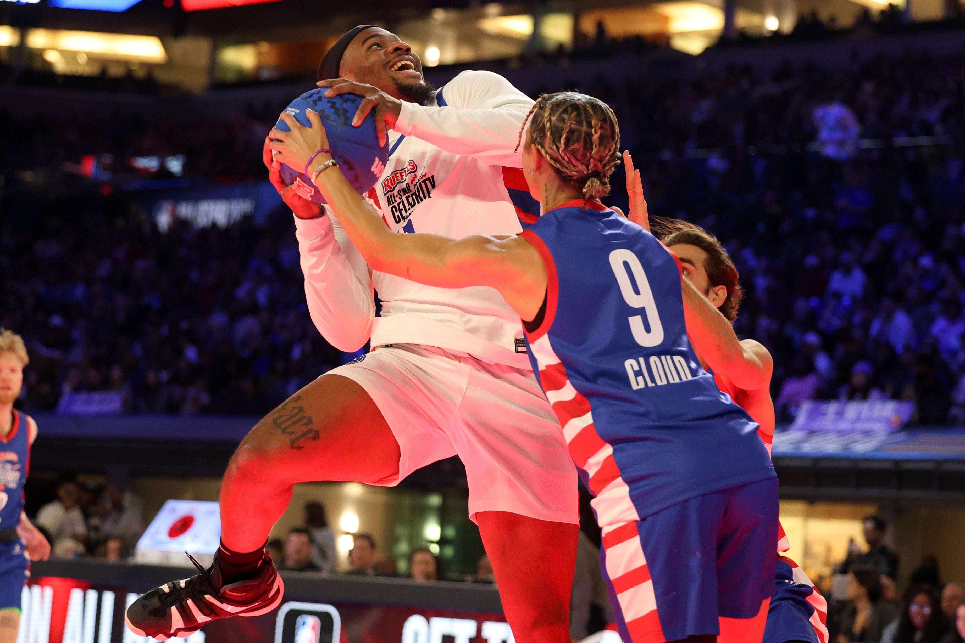 Micah Parsons goes for a contact layup in the NBA celebrity All-Star game