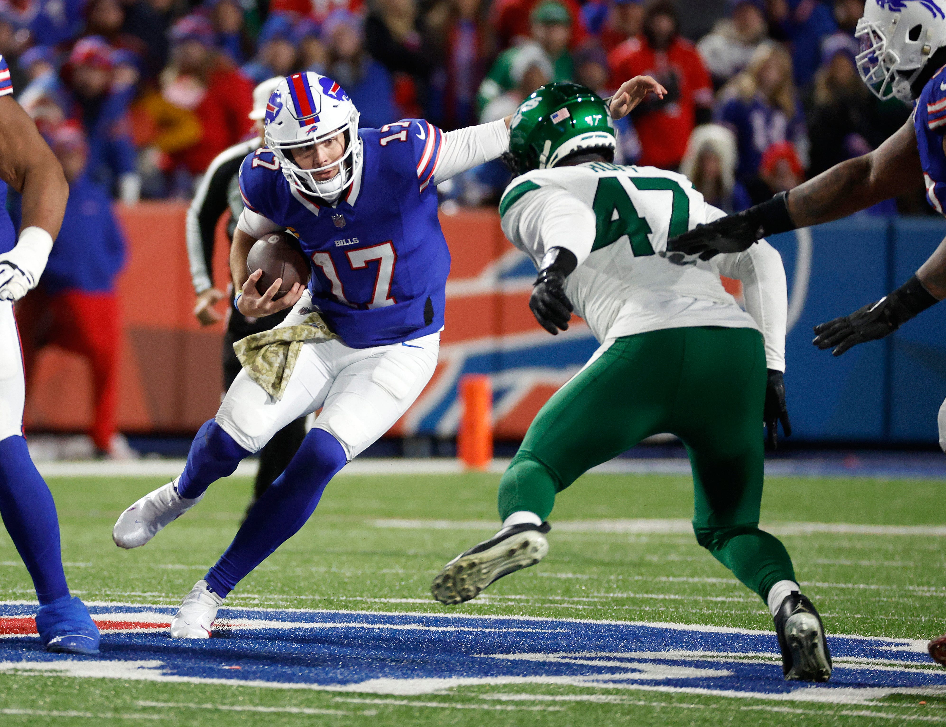 Buffalo Bills quarterback Josh Allen (17) tries to get around New York Jets linebacker Bryce Huff (47).