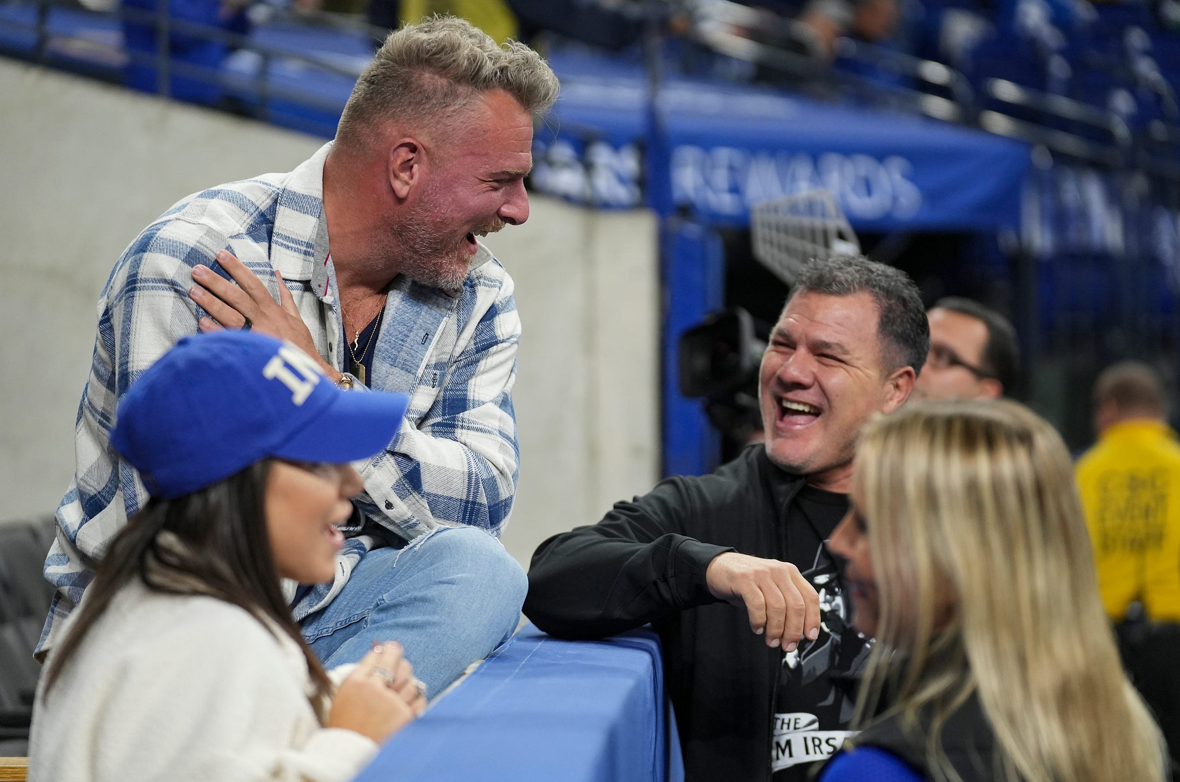 Former Indianapolis Colts Pat McAfee and Adam Vinatieri greet each other Sunday, Nov. 26, 2023, before the Colts face the Tampa Bay Buccaneers at Lucas Oil Stadium in Indianapolis.