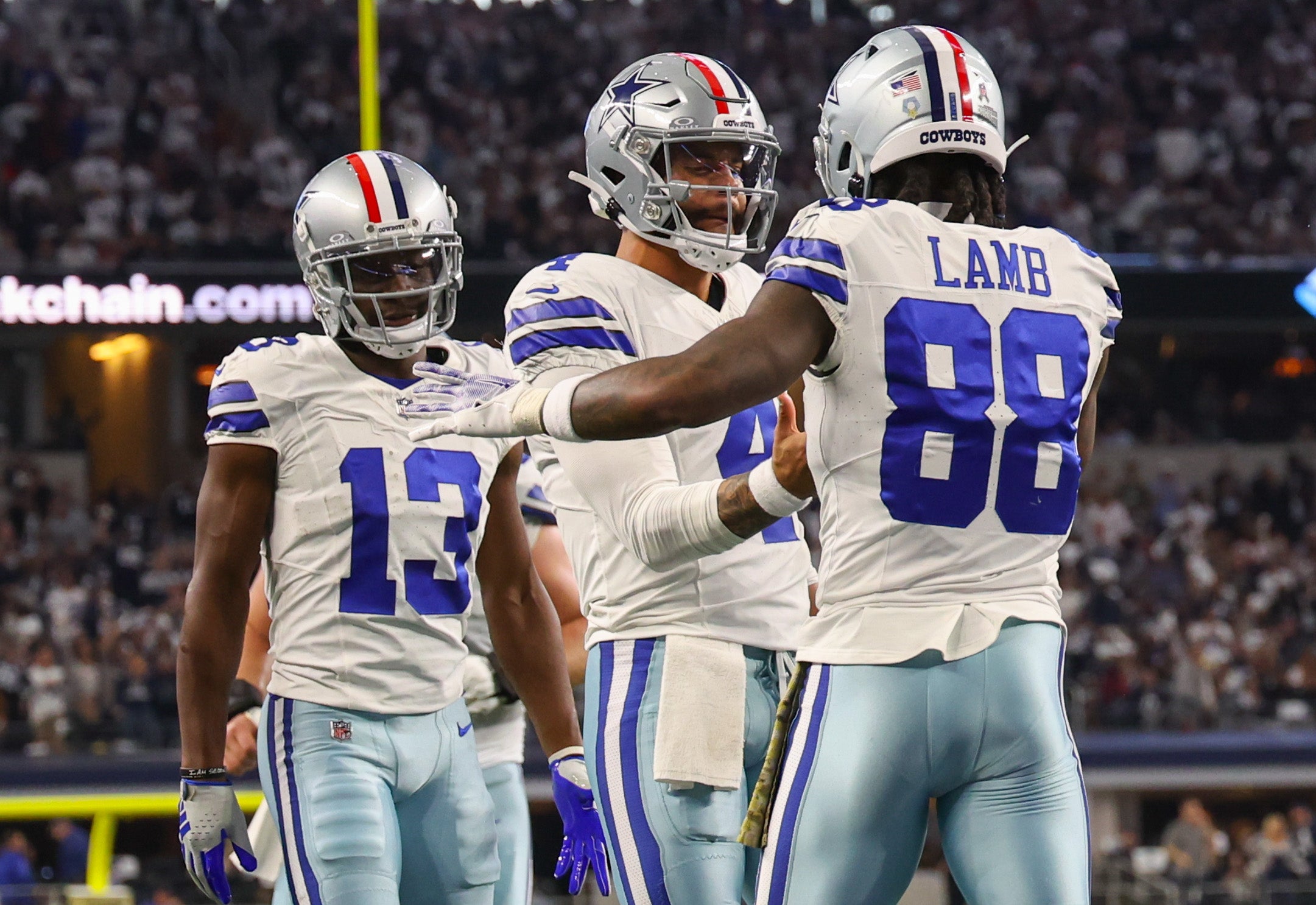 Dallas Cowboys wide receiver CeeDee Lamb (88) celebrates with Dallas Cowboys quarterback Dak Prescott (4) after scoring a touchdown during the first quarter against the New York Giants at AT&T Stadium.