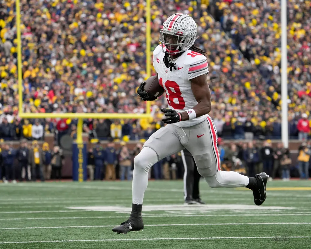 Ohio State Buckeyes wide receiver Marvin Harrison Jr. (18) toward the end zone during the second half of Saturday's NCAA Division I football game against the University of Michigan