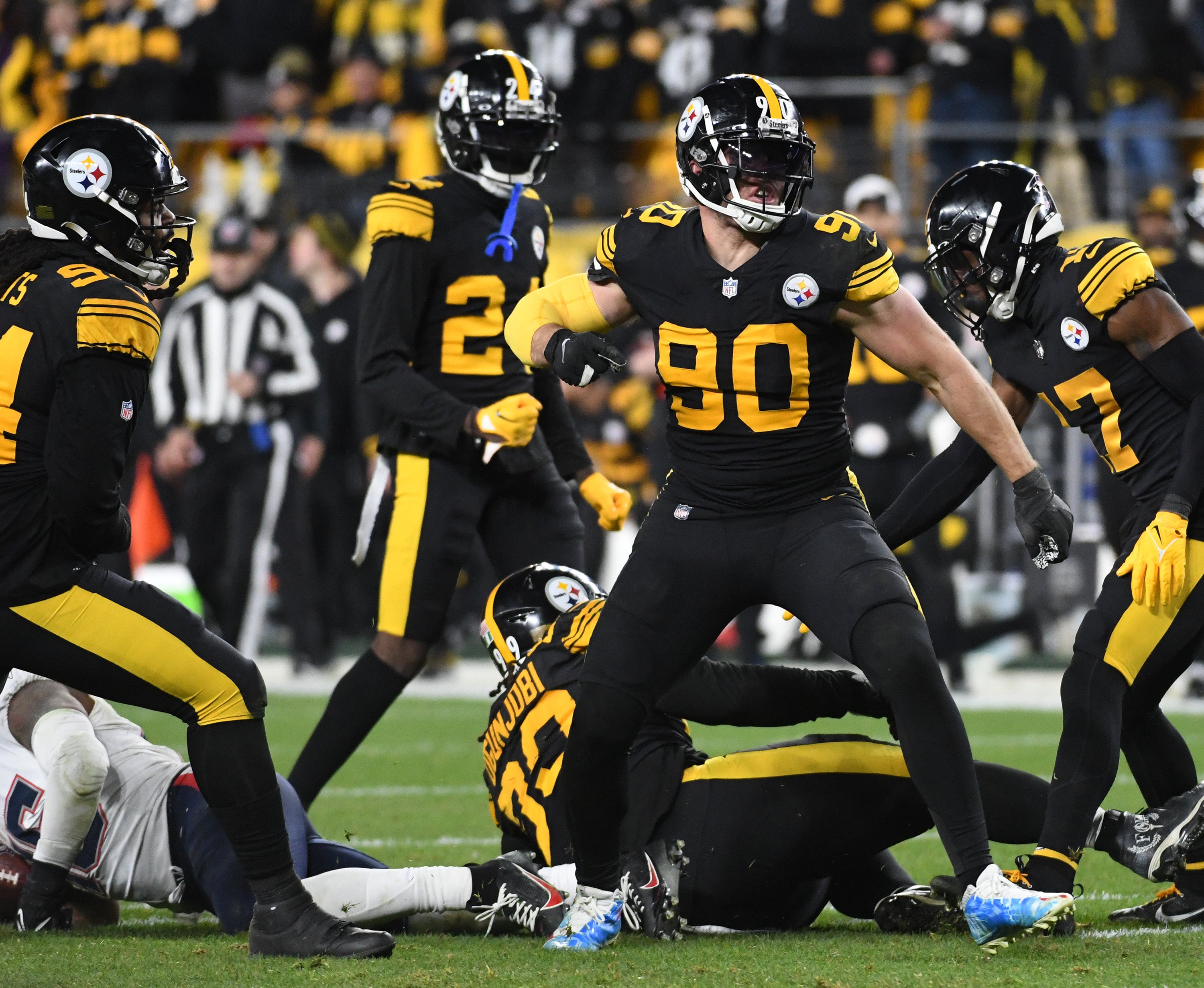 Dec 7, 2023; Pittsburgh, Pennsylvania, USA; Pittsburgh Steelers linebacker T.J. Watt (90) celebrates a tackle of New England Patriots running back Ezekiel Elliott (15) during the fourth quarter at Acrisure Stadium. The Patriots won 21-18. Mandatory Credit: Philip G. Pavely-USA TODAY Sports