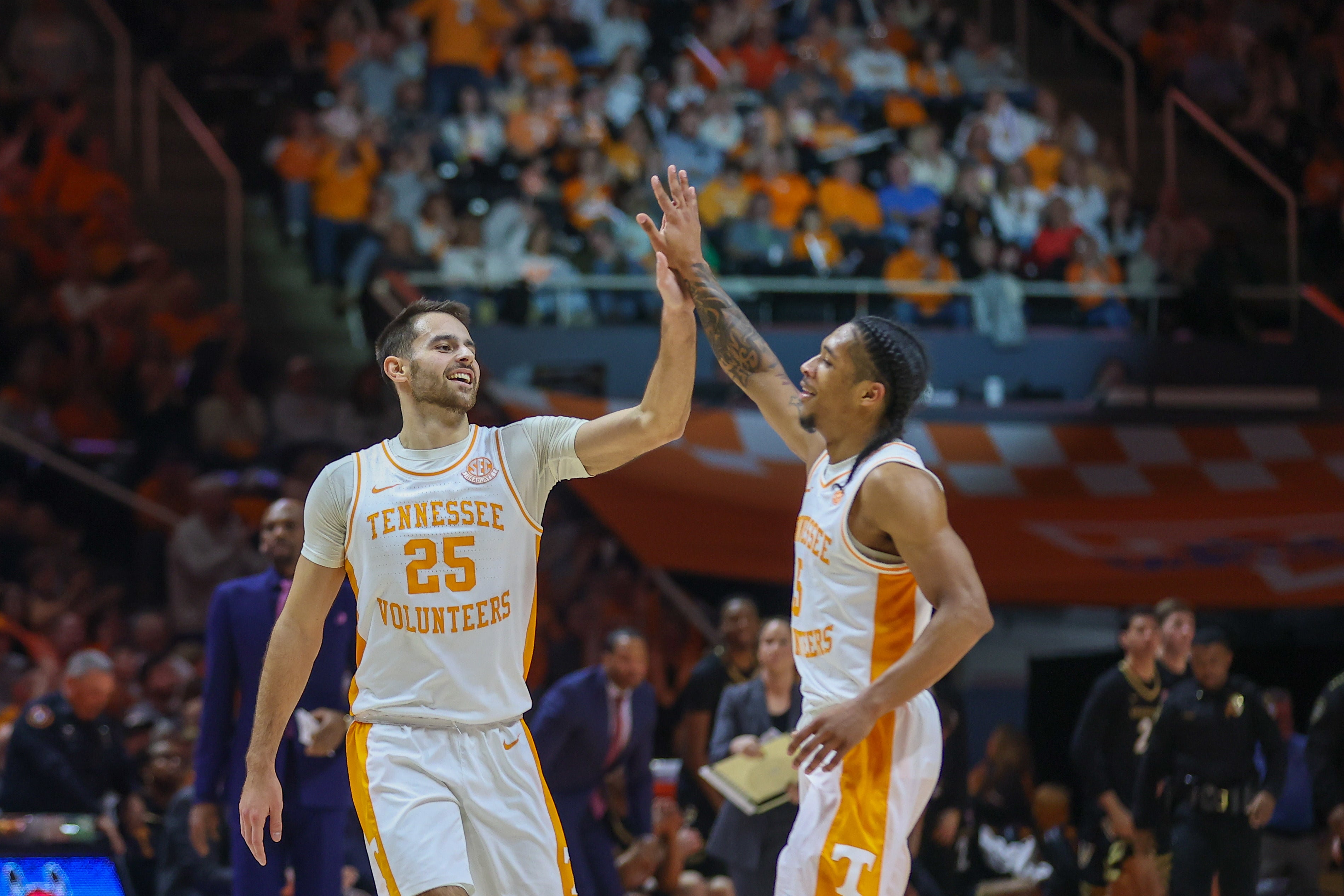 Feb 17, 2024; Knoxville, Tennessee, USA; Tennessee Volunteers guard Santiago Vescovi (25) and guard Zakai Zeigler (5) react after Vescovi scored a three pointer against the Vanderbilt Commodores during the first half at Thompson-Boling Arena at Food City Center.