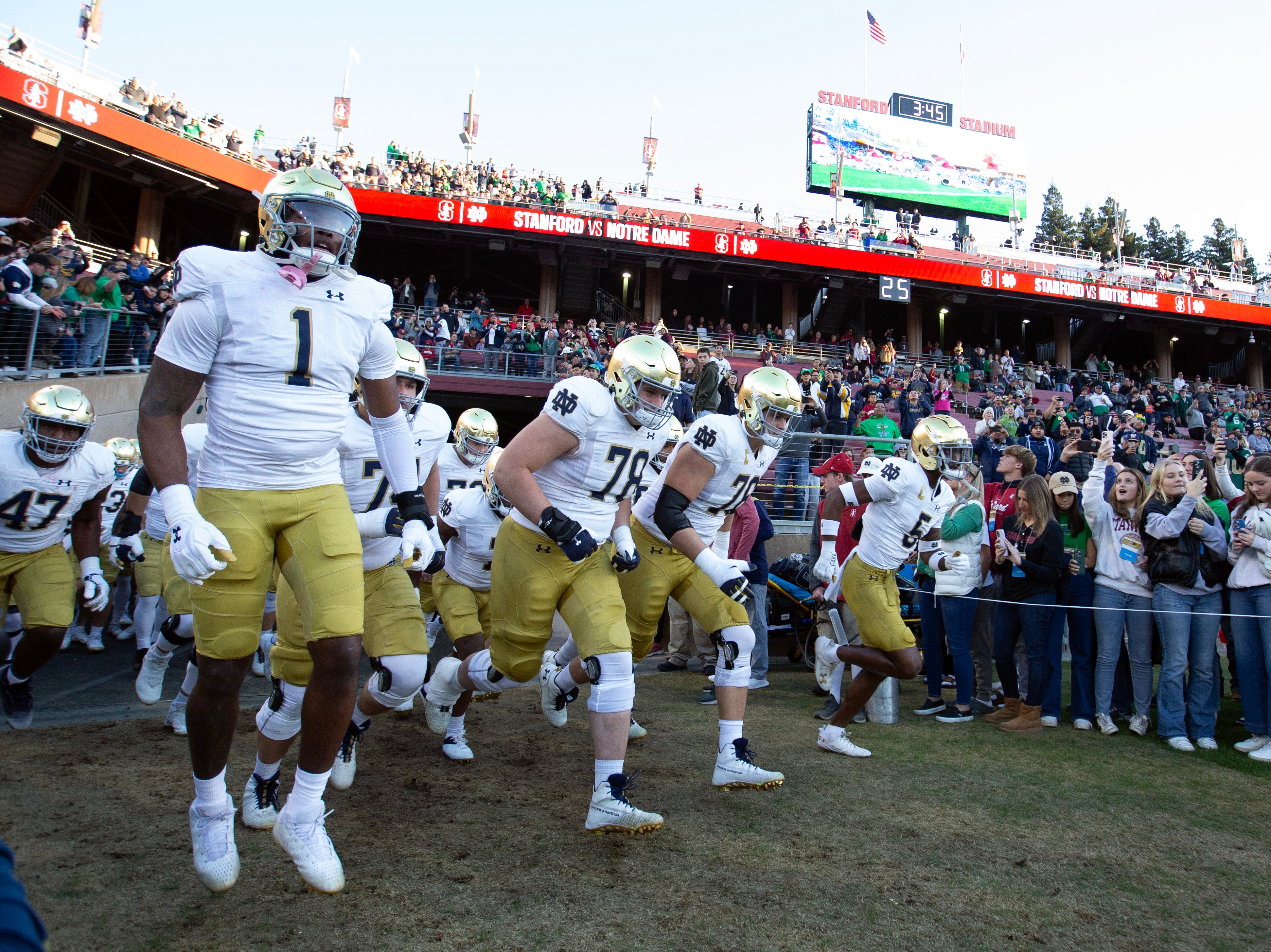 Nov 25, 2023; Stanford, California, USA; Notre Dame Fighting Irish players take the field against the Stanford Cardinal at Stanford Stadium.