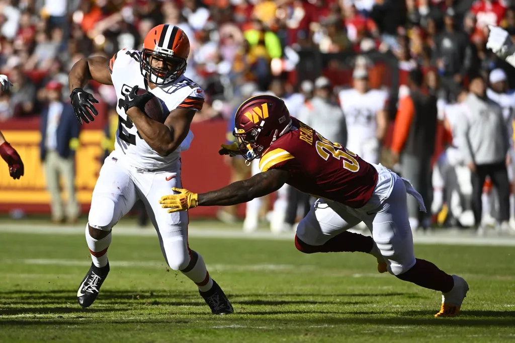Cleveland Browns running back Nick Chubb (24) carries the ball as Washington Commanders safety Jeremy Reaves (39) defends during the first half at FedExField.