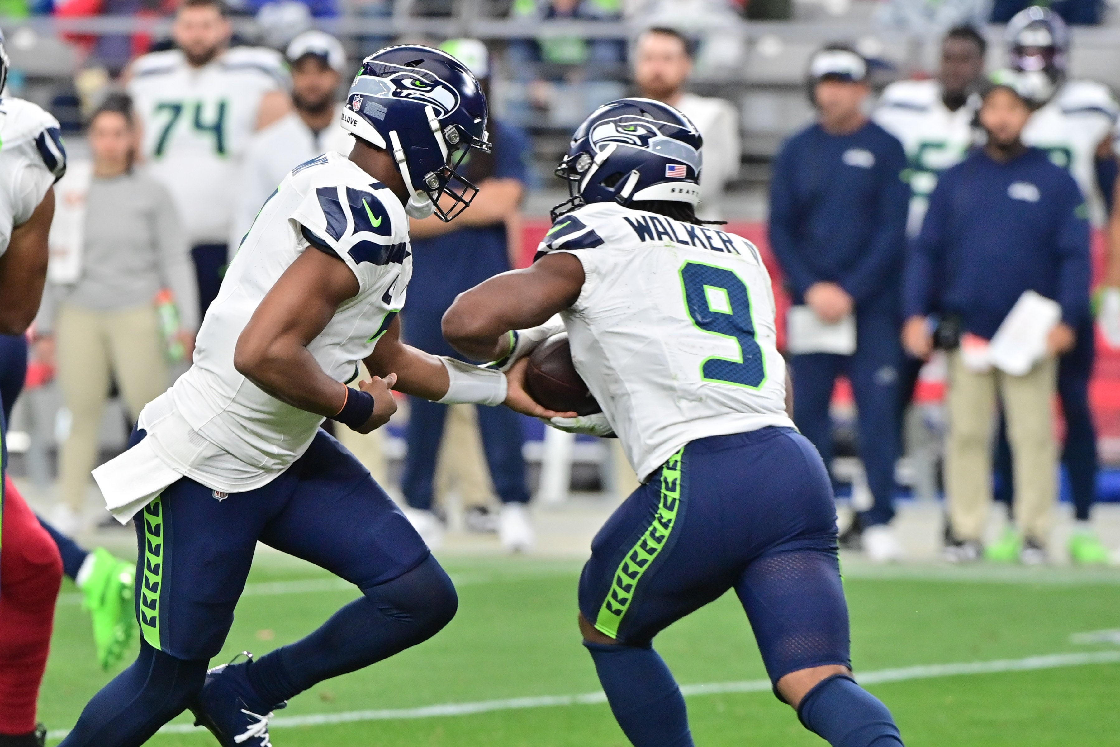 Jan 7, 2024; Glendale, Arizona, USA; Seattle Seahawks quarterback Geno Smith (7) hands off to running back Kenneth Walker III (9) in the first half against the Arizona Cardinals at State Farm Stadium.