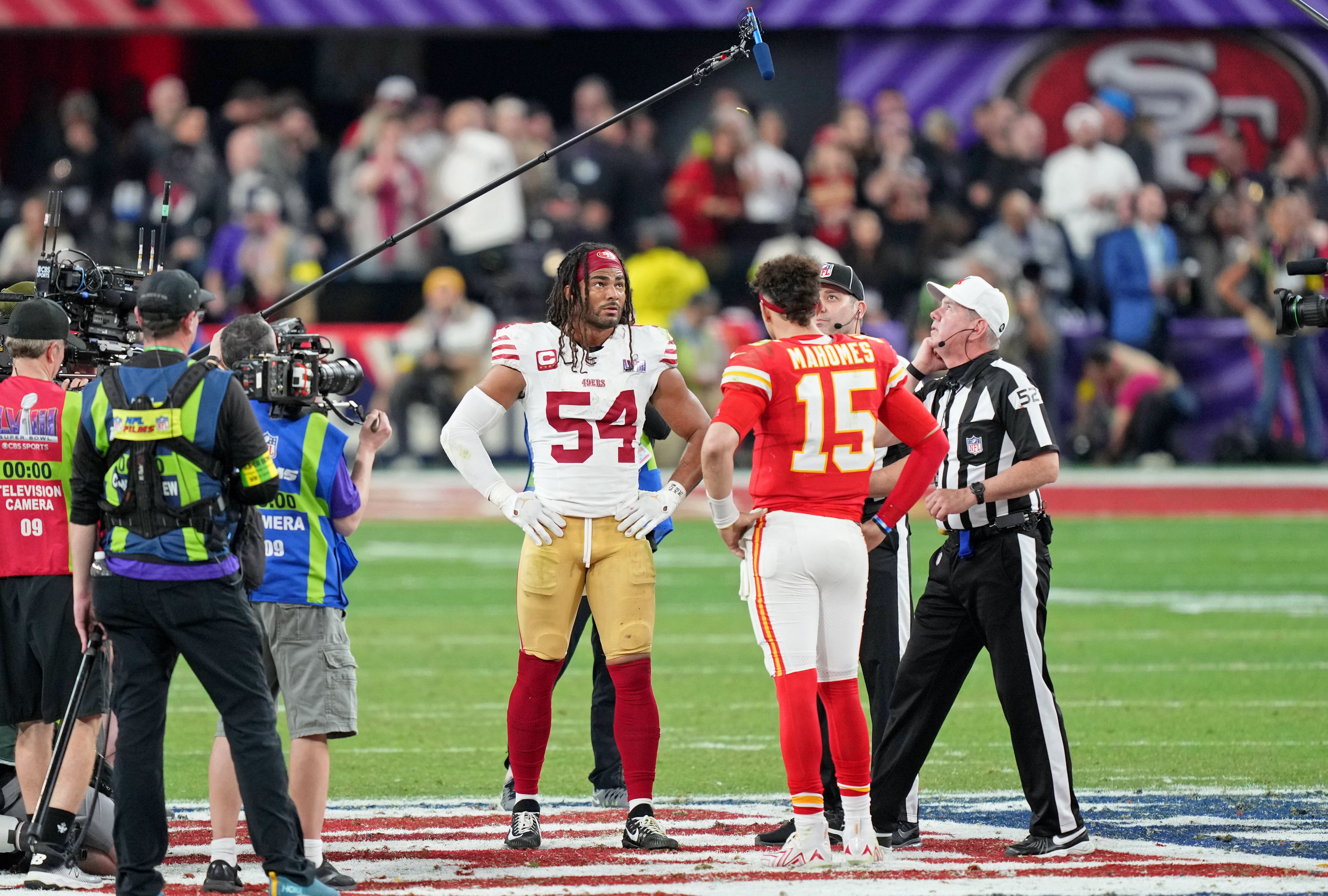Feb 11, 2024; Paradise, Nevada, USA; San Francisco 49ers linebacker Fred Warner (54) and Kansas City Chiefs quarterback Patrick Mahomes (15) during the coin toss before overtime of Super Bowl LVIII at Allegiant Stadium.