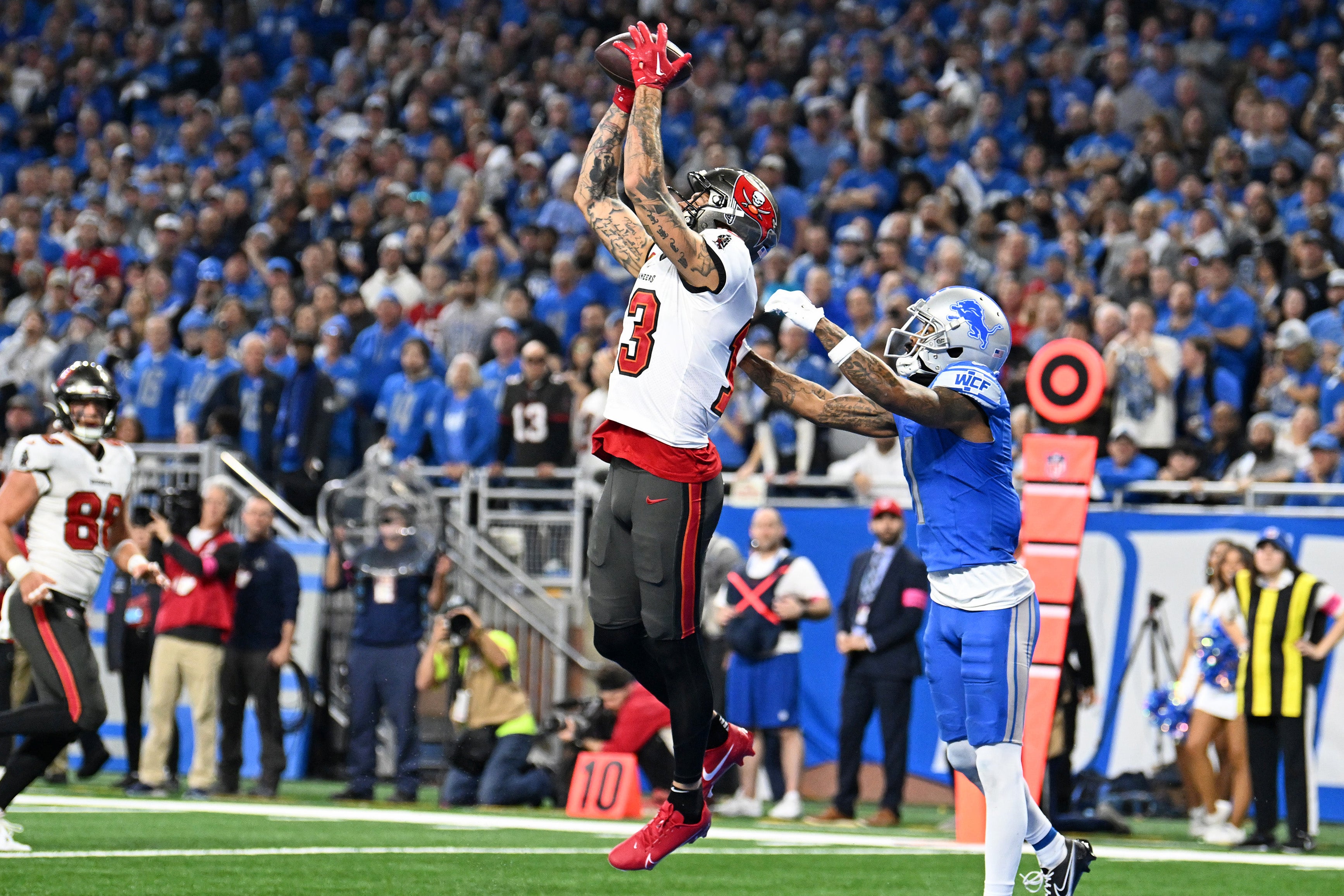Jan 21, 2024; Detroit, Michigan, USA; Tampa Bay Buccaneers wide receiver Mike Evans (13) makes a catch against Detroit Lions cornerback Cameron Sutton (1) during the second half in a 2024 NFC divisional round game at Ford Field.