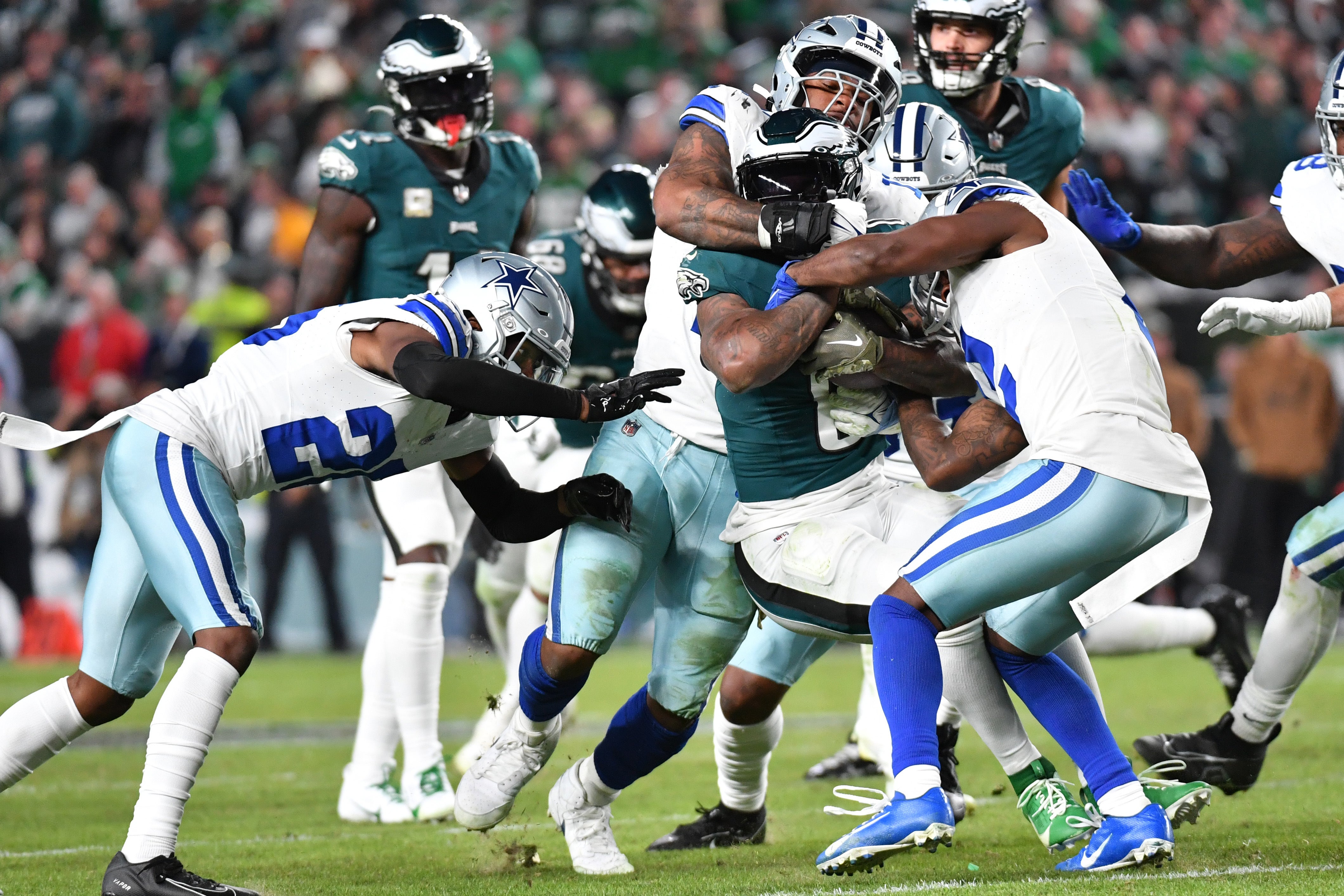 Philadelphia Eagles running back D'Andre Swift (0) is tackled by Dallas Cowboys linebacker Micah Parsons (11) and Dallas Cowboys cornerback Jourdan Lewis (2) at Lincoln Financial Field.