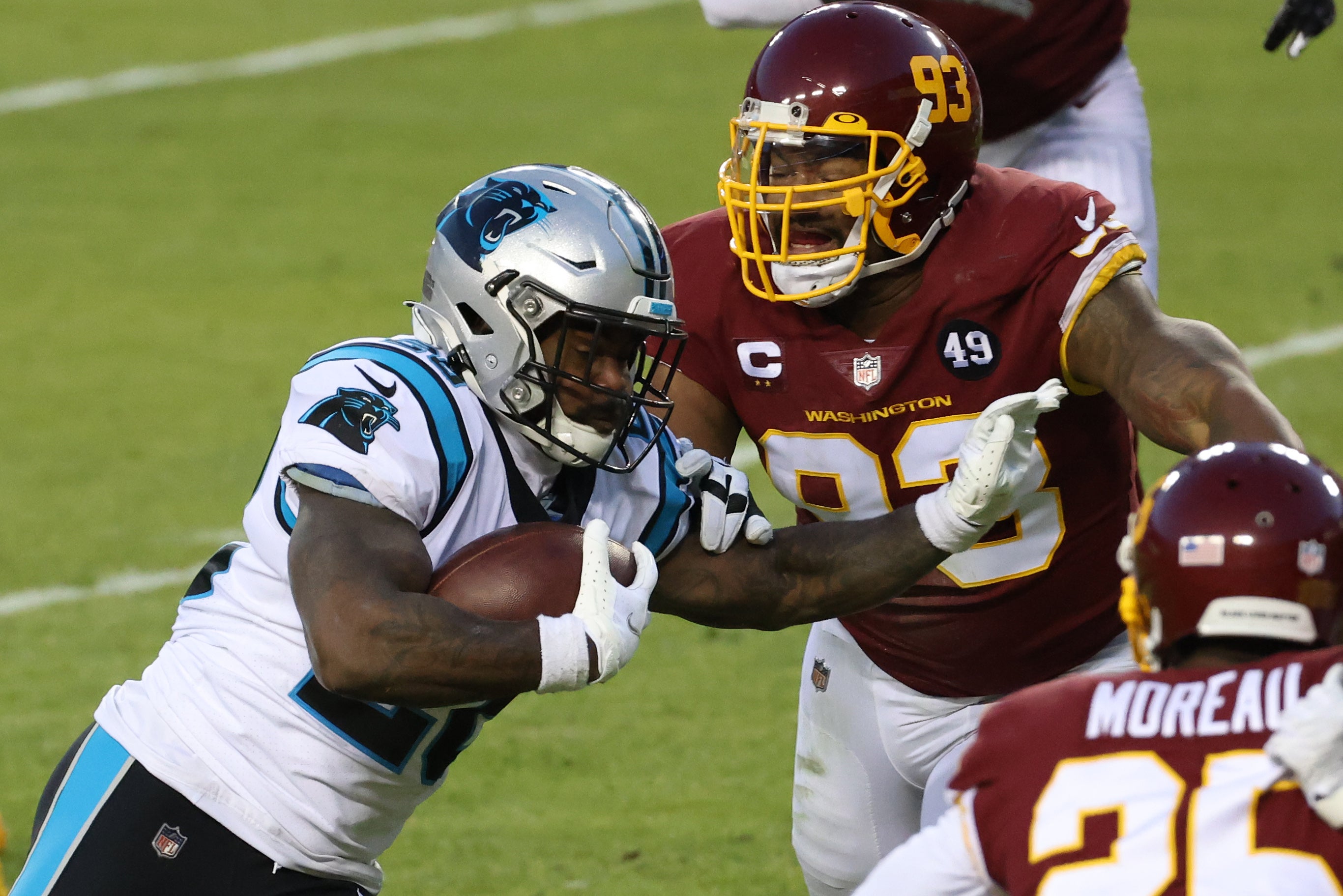 Dec 27, 2020; Landover, Maryland, USA; Carolina Panthers running back Mike Davis (28) carries the ball as Washington Football Team defensive tackle Jonathan Allen (93) chases in the second quarter at FedExField. Mandatory Credit: Geoff Burke-USA TODAY Sports