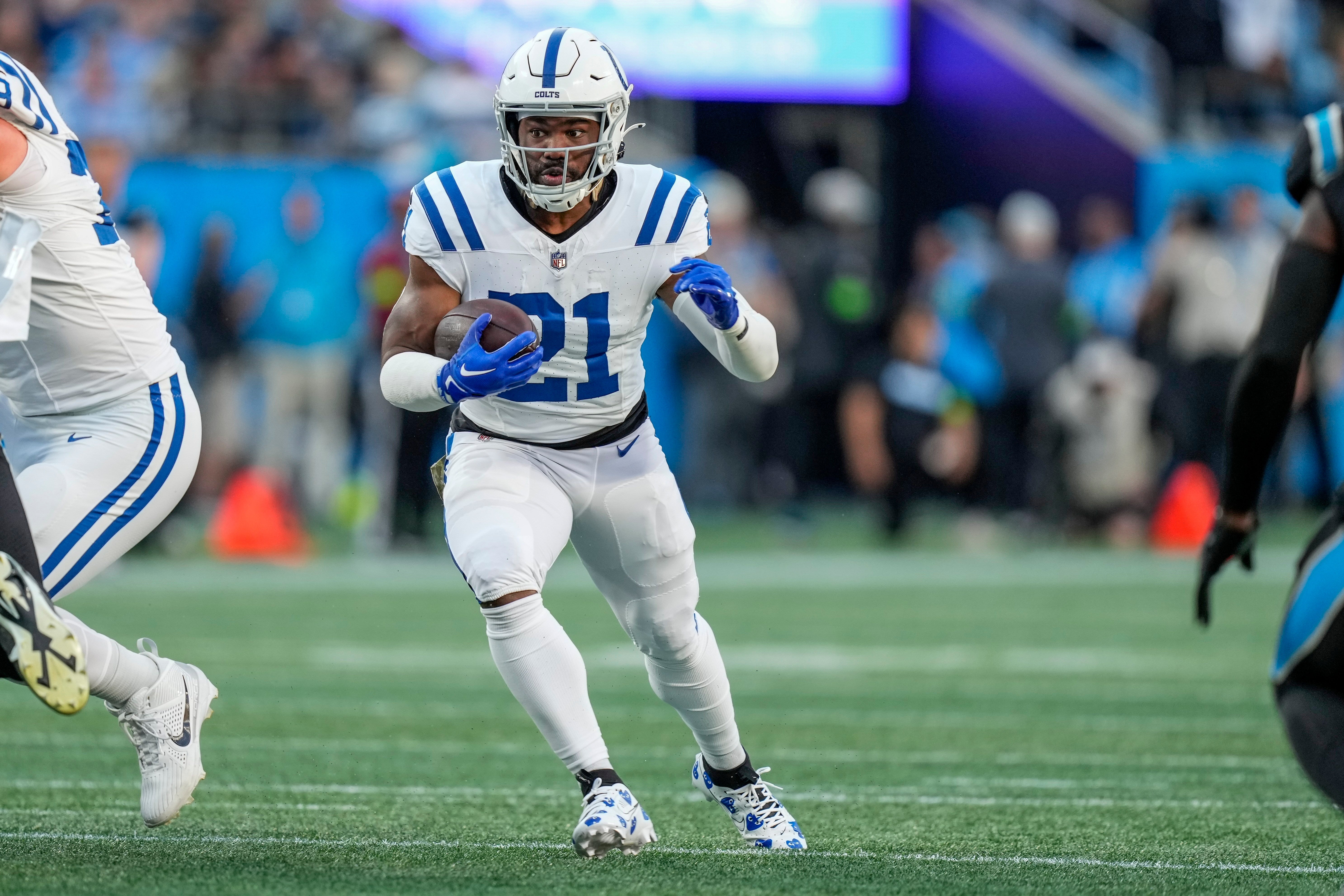Nov 5, 2023; Charlotte, North Carolina, USA; Indianapolis Colts running back Zack Moss (21) runs through an opening against the Carolina Panthers during the first quarter at Bank of America Stadium.
