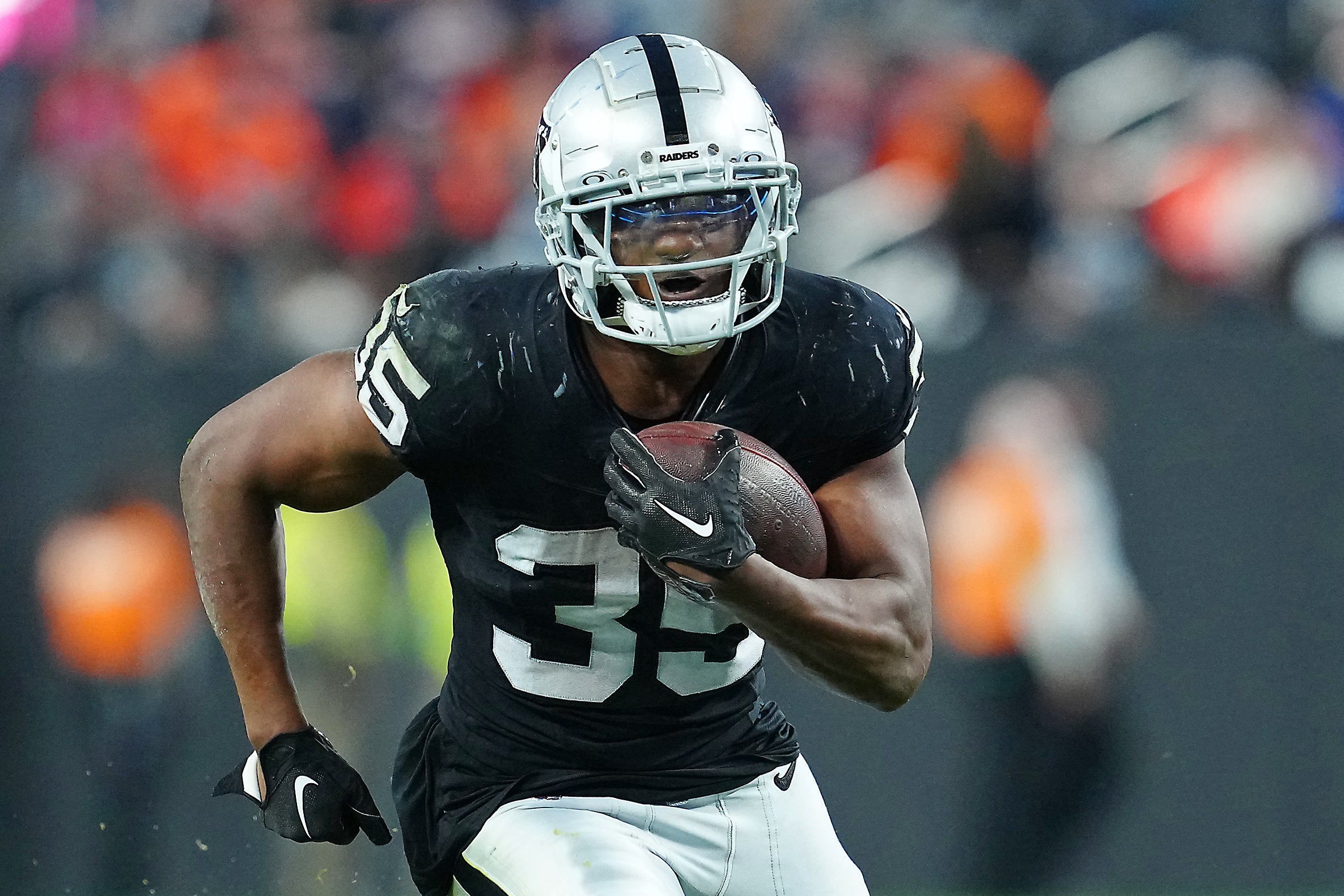 Las Vegas Raiders running back Zamir White (35) gains yardage against the Denver Broncos during the fourth quarter