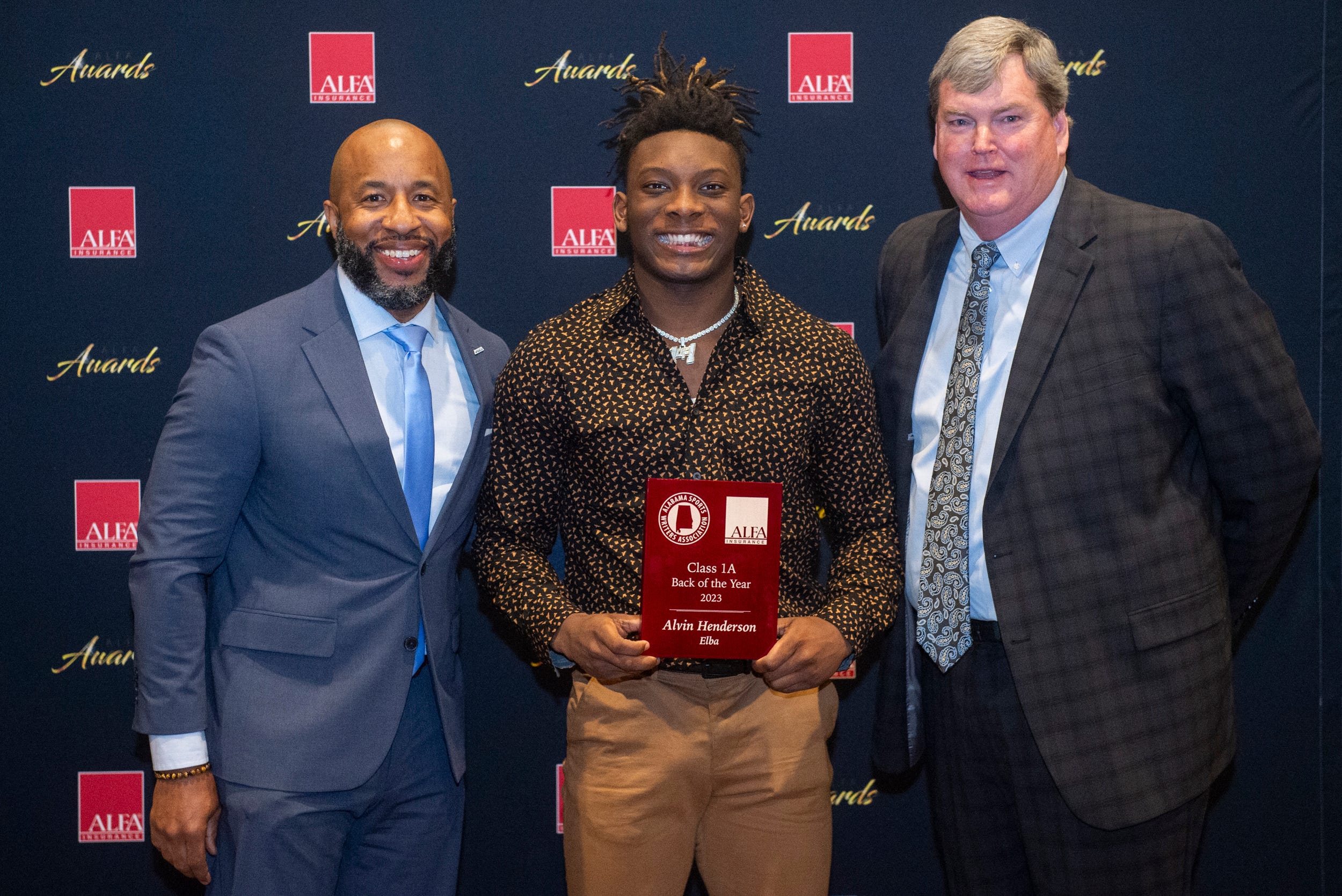 Class 1A back of the year Elba s Alvin Henderson poses with Brandon Dean, director of Alabama High School Athletic Directors and Coaches Association, left, and Alfa Insurance s Scott Stricklin, right, during the Alabama Sports Writers Association s players of the year banquet at Renaissance Hotel in Montgomery, Ala., on Tuesday, Jan. 30, 2024.