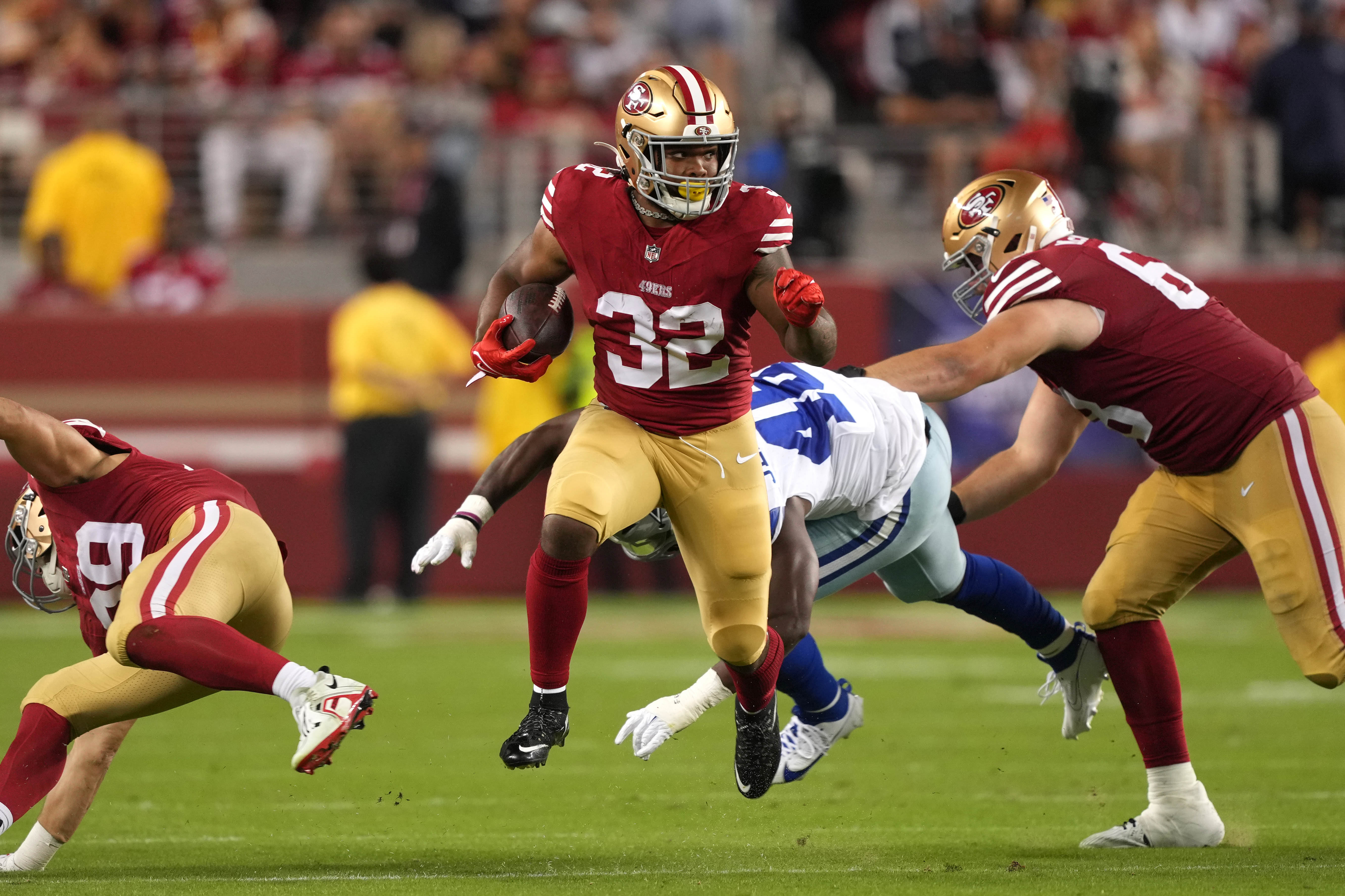 Oct 8, 2023; Santa Clara, California, USA; San Francisco 49ers running back Tyrion Davis-Price (32) carries the ball against Dallas Cowboys linebacker Malik Jefferson (46) as offensive tackle Colton McKivitz (right) blocks during the fourth quarter at Levi's Stadium.
