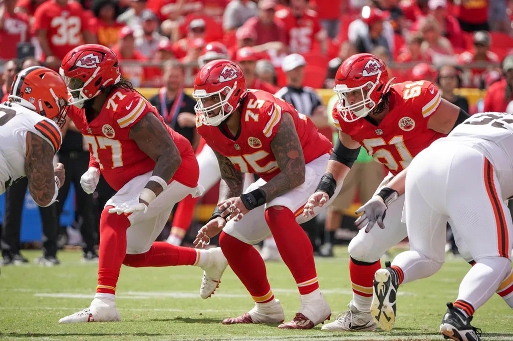 Kansas City Chiefs offensive tackle Lucas Niang (77) and offensive tackle Darian Kinnard (75) and center Austin Reiter (61) on the line of scrimmage against the Cleveland Browns during the game.