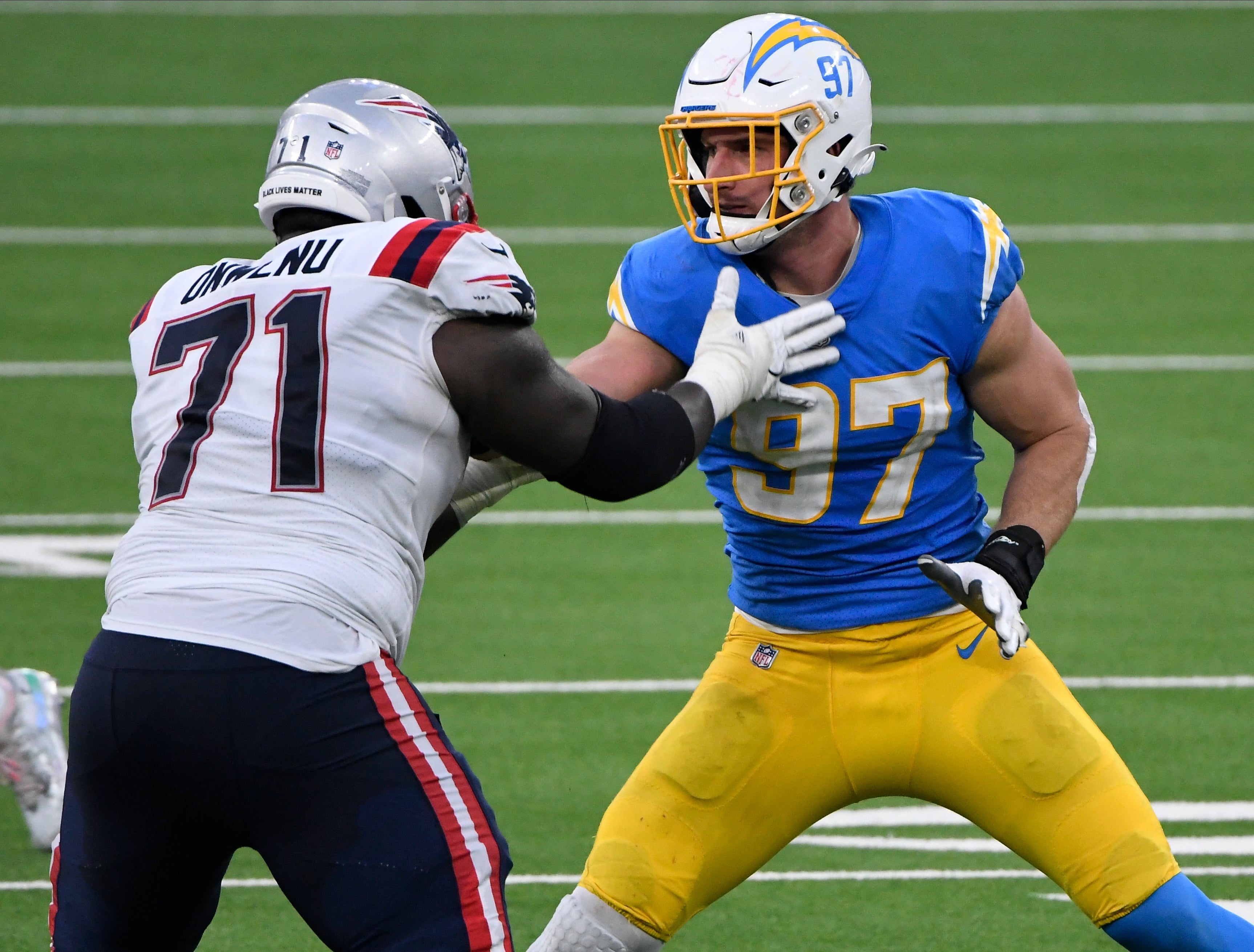 Dec 6, 2020; Inglewood, California, USA; Los Angeles Chargers defensive end Joey Bosa (97) battler New England Patriots offensive tackle Mike Onwenu (71) at the line during the third quarter at SoFi Stadium.
