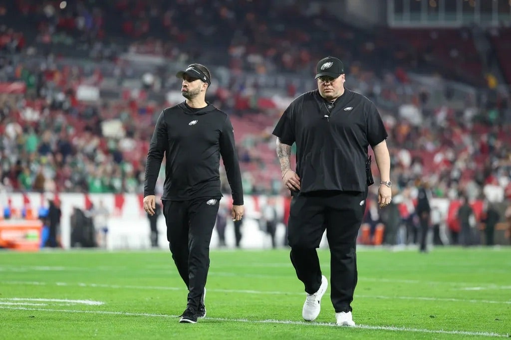 Philadelphia Eagles head coach Nick Sirianni and chief security officer Dom DiSandro walk off the field before a 2024 NFC wild card game against the Tampa Bay Buccaneers during an NFL NFC Wild Card playoffs.