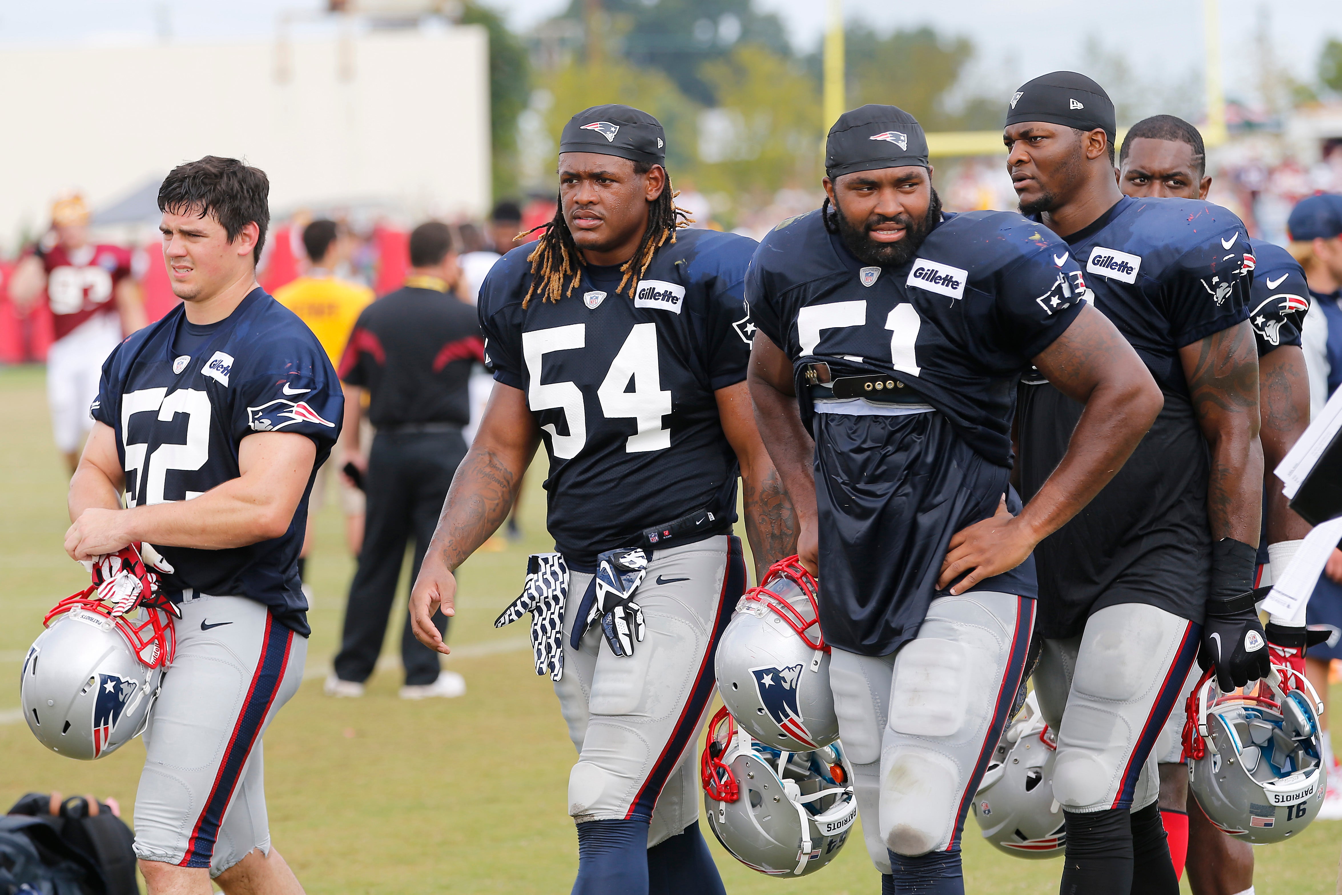 Aug 4, 2014; Richmond, VA, USA; New England Patriots linebacker James Morris (52), Patriots outside linebacker Dont'a Hightower (54), and Patriots outside linebacker Jerod Mayo (51) leave the field after joint practice with the New England Patriots on day ten of training camp at the Bon Secours Washington Redskins Training Center.