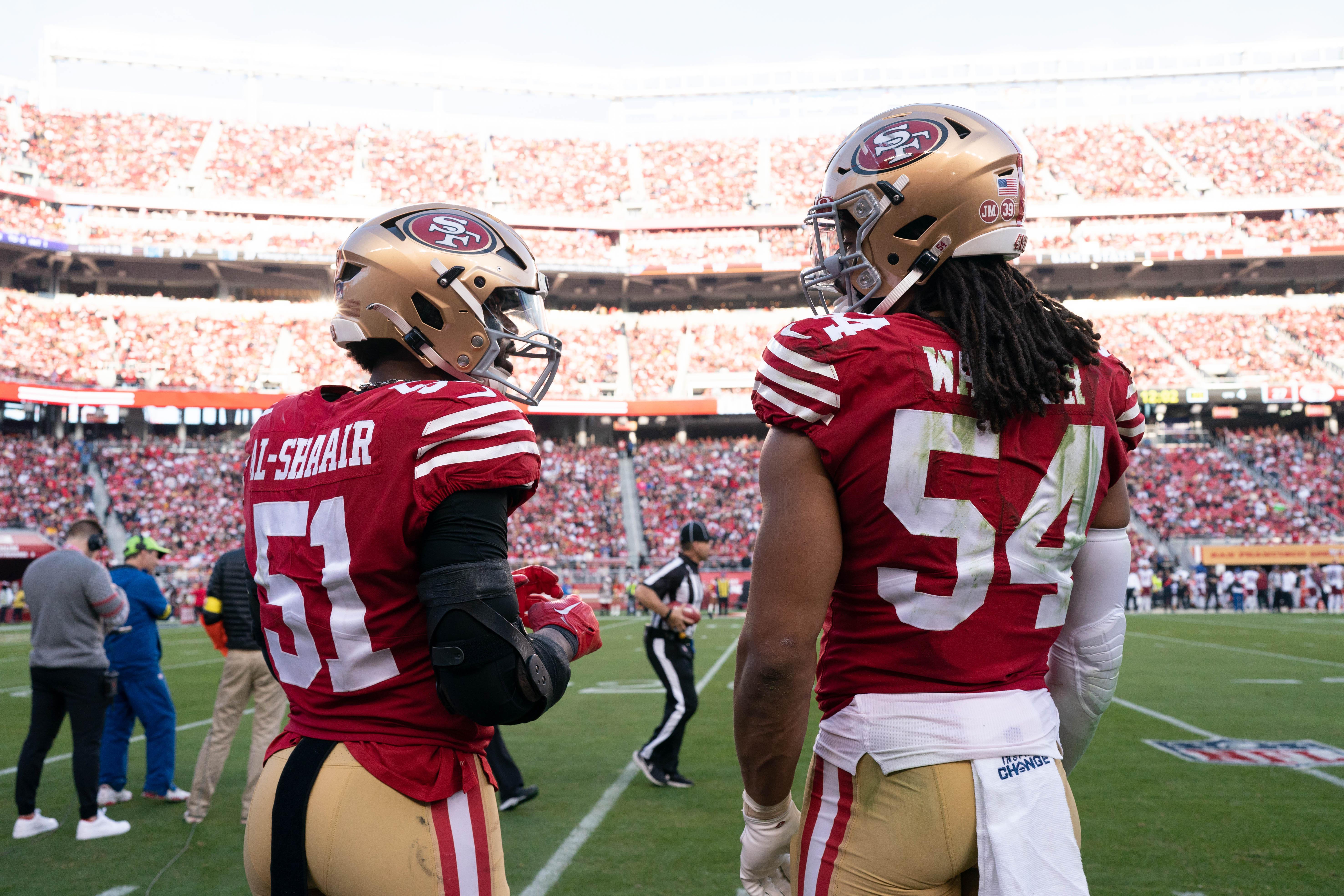Dec 24, 2022; Santa Clara, California, USA; San Francisco 49ers linebacker Azeez Al-Shaair (51) converse with linebacker Fred Warner (54) on the sidelines during the fourth quarter against the Washington Commanders at Levi's Stadium.