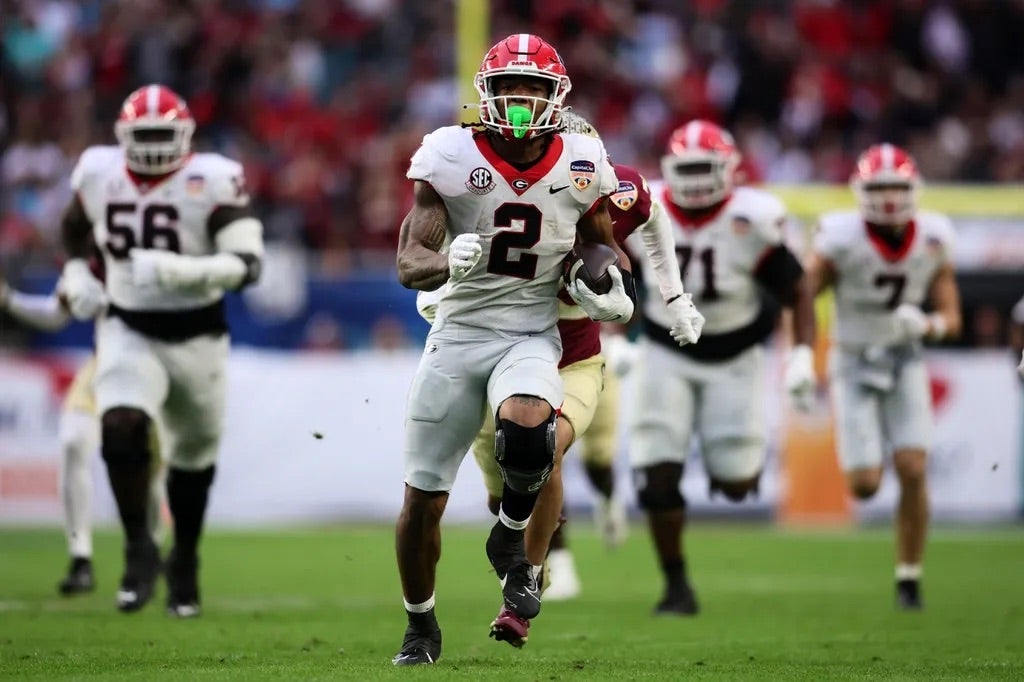Georgia Bulldogs running back Kendall Milton (2) rushes the ball against the Florida State Seminoles during the first half in the 2023 Orange Bowl at Hard Rock Stadium.