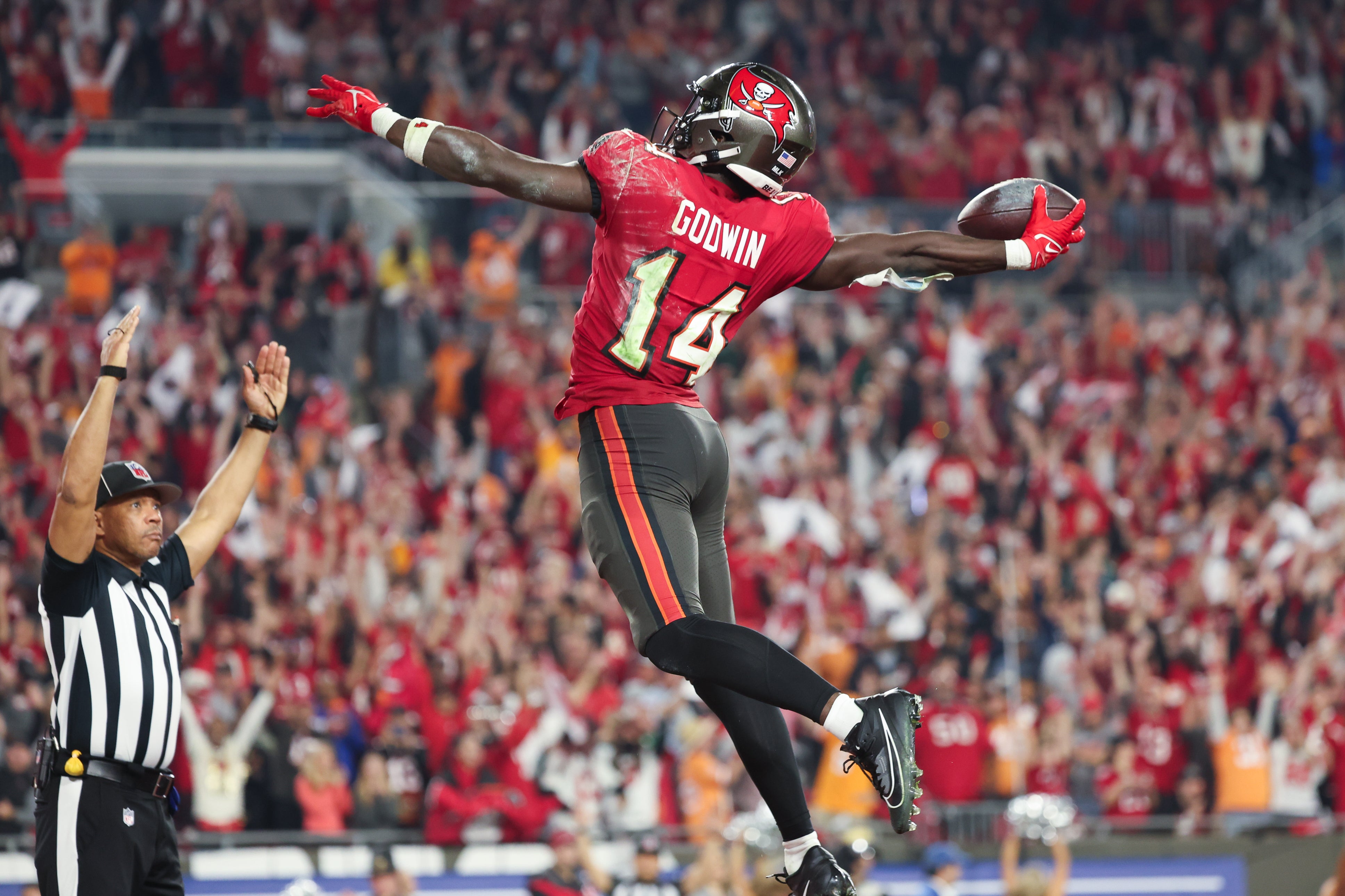 Jan 15, 2024; Tampa, Florida, USA; Tampa Bay Buccaneers wide receiver Chris Godwin (14) celebrates his touchdown against the Philadelphia Eagles during the second half of a 2024 NFC wild card game at Raymond James Stadium.
