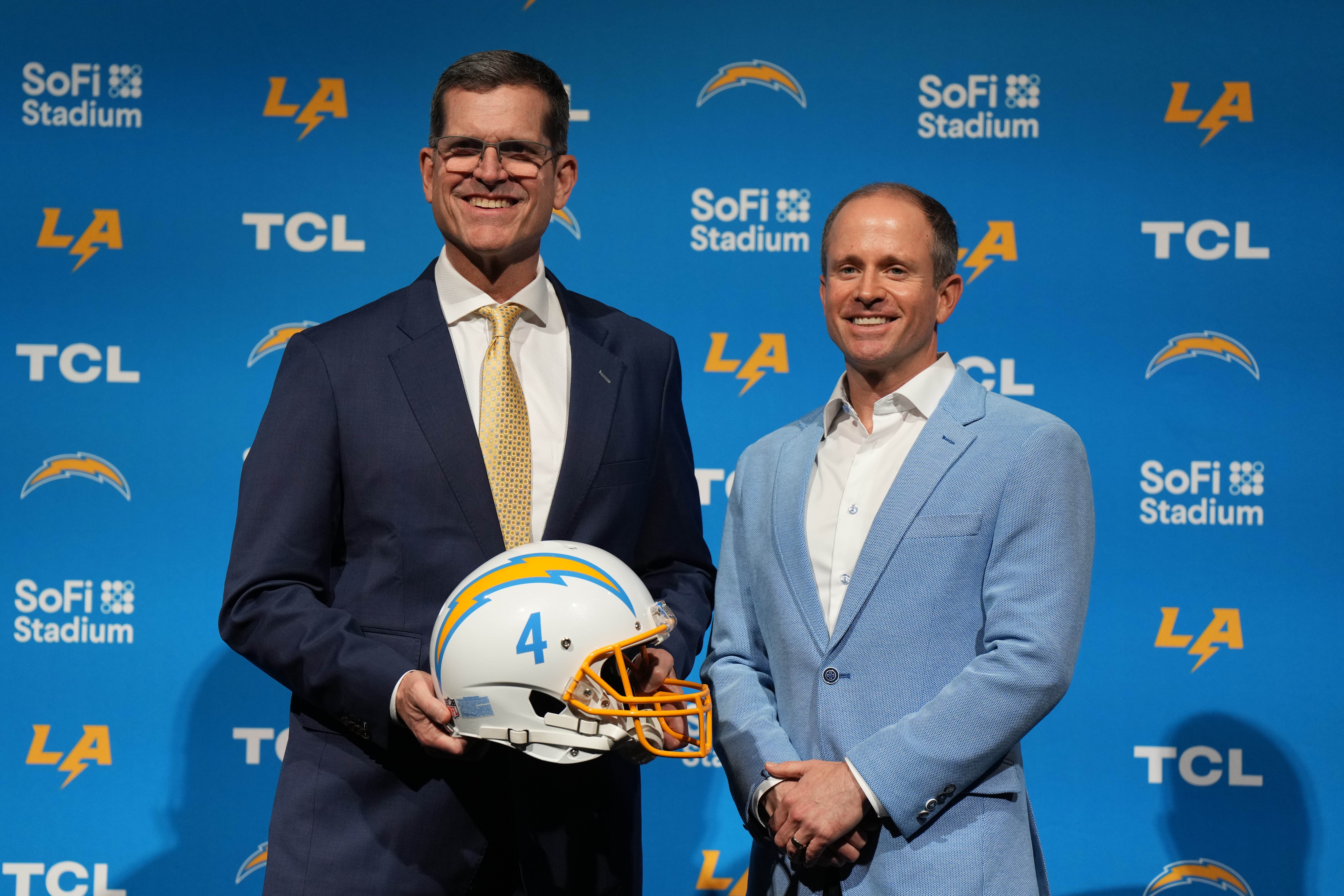 Feb 1, 2024; Inglewood, CA, USA; Los Angeles Chargers coach Jim Harbaugh (left) poses with president of football operations John Spanos at an introductory press conference at YouTube Theater at SoFi Stadium.
