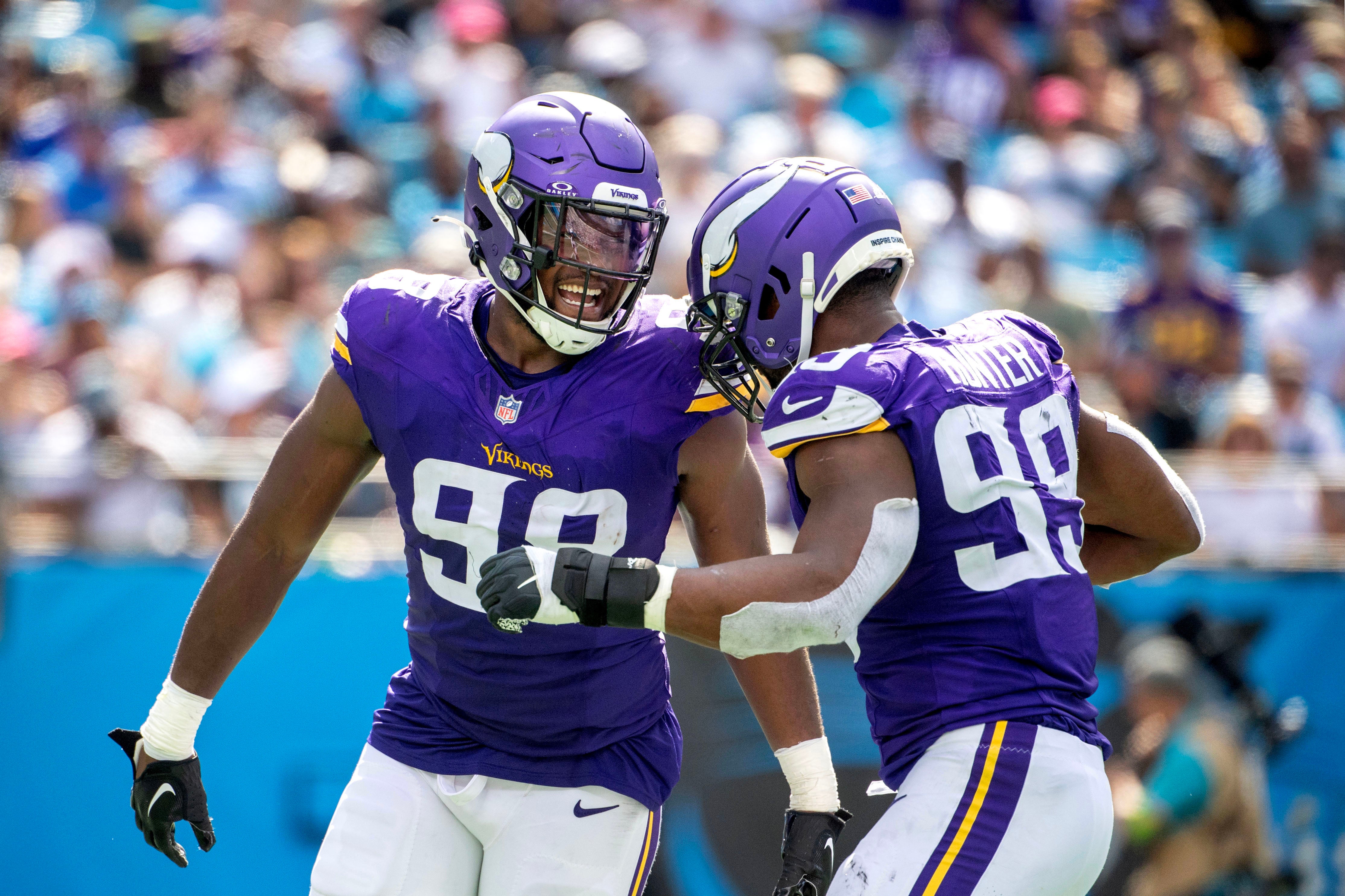 Oct 1, 2023; Charlotte, North Carolina, USA; Minnesota Vikings linebacker D.J. Wonnum (98) celebrates with linebacker Danielle Hunter (99) after a sack in the third quarter at Bank of America Stadium. Mandatory Credit: Bob Donnan-USA TODAY Sports