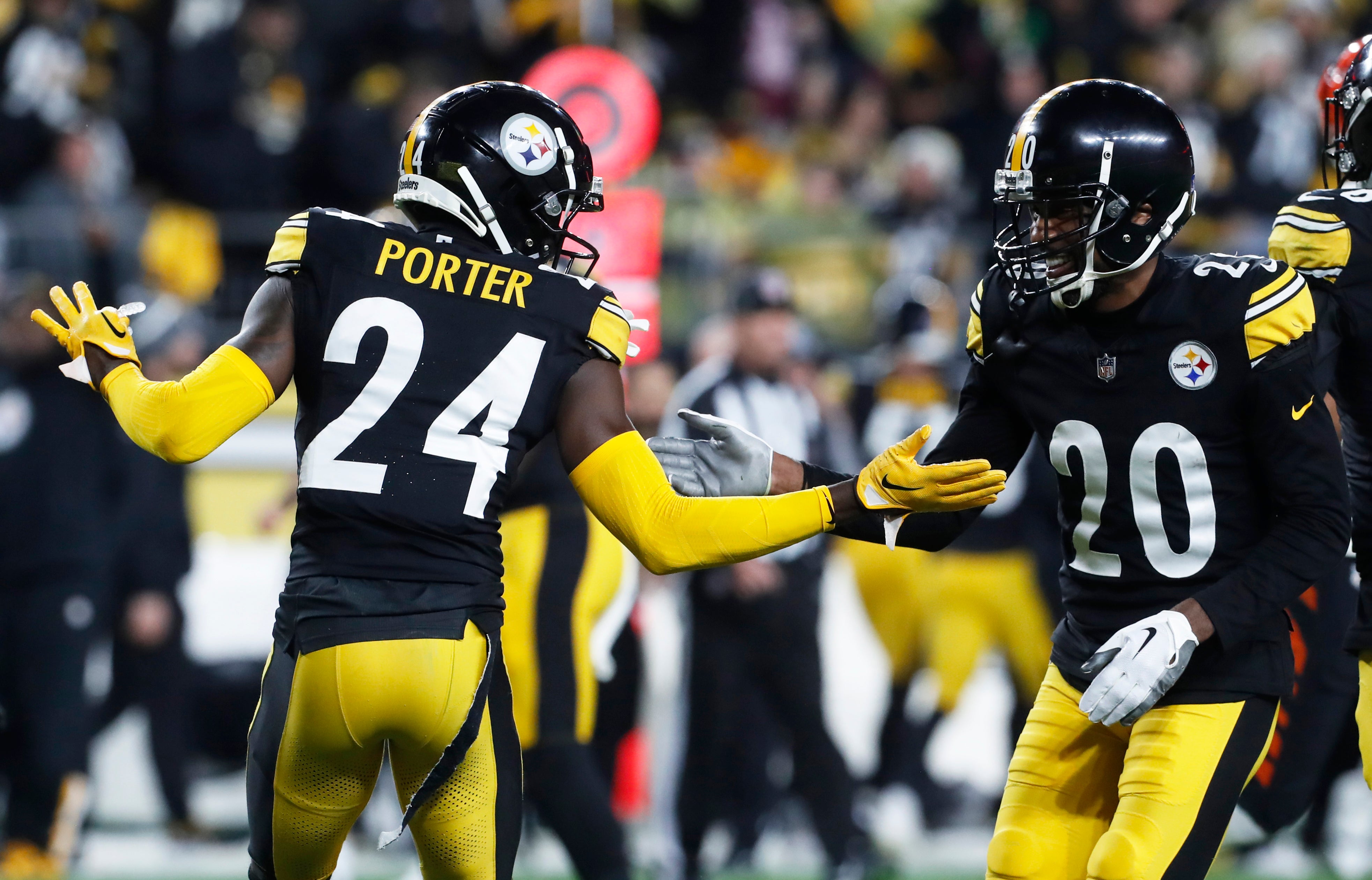 Dec 23, 2023; Pittsburgh, Pennsylvania, USA; Pittsburgh Steelers cornerback Joey Porter Jr. (24) and cornerback Patrick Peterson (20) celebrate a defensive stop against the Cincinnati Bengals during the third quarter at Acrisure Stadium. Pittsburgh won 34-11. Mandatory Credit: Charles LeClaire-USA TODAY Sports  