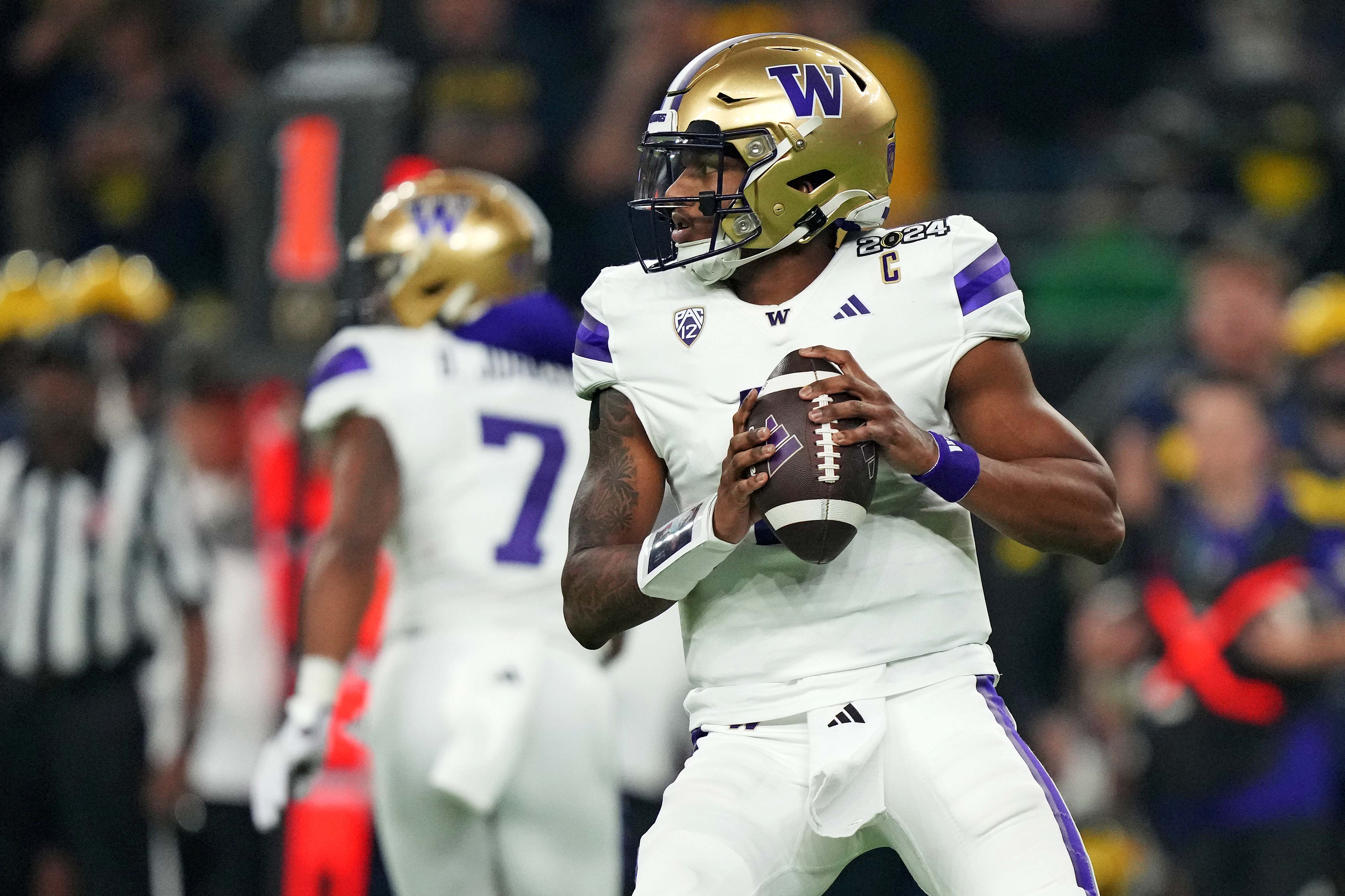Jan 8, 2024; Houston, TX, USA; Washington Huskies quarterback Michael Penix Jr. (9) drops back to throws a pass during the second quarter against the Michigan Wolverines in the 2024 College Football Playoff national championship game at NRG Stadium.