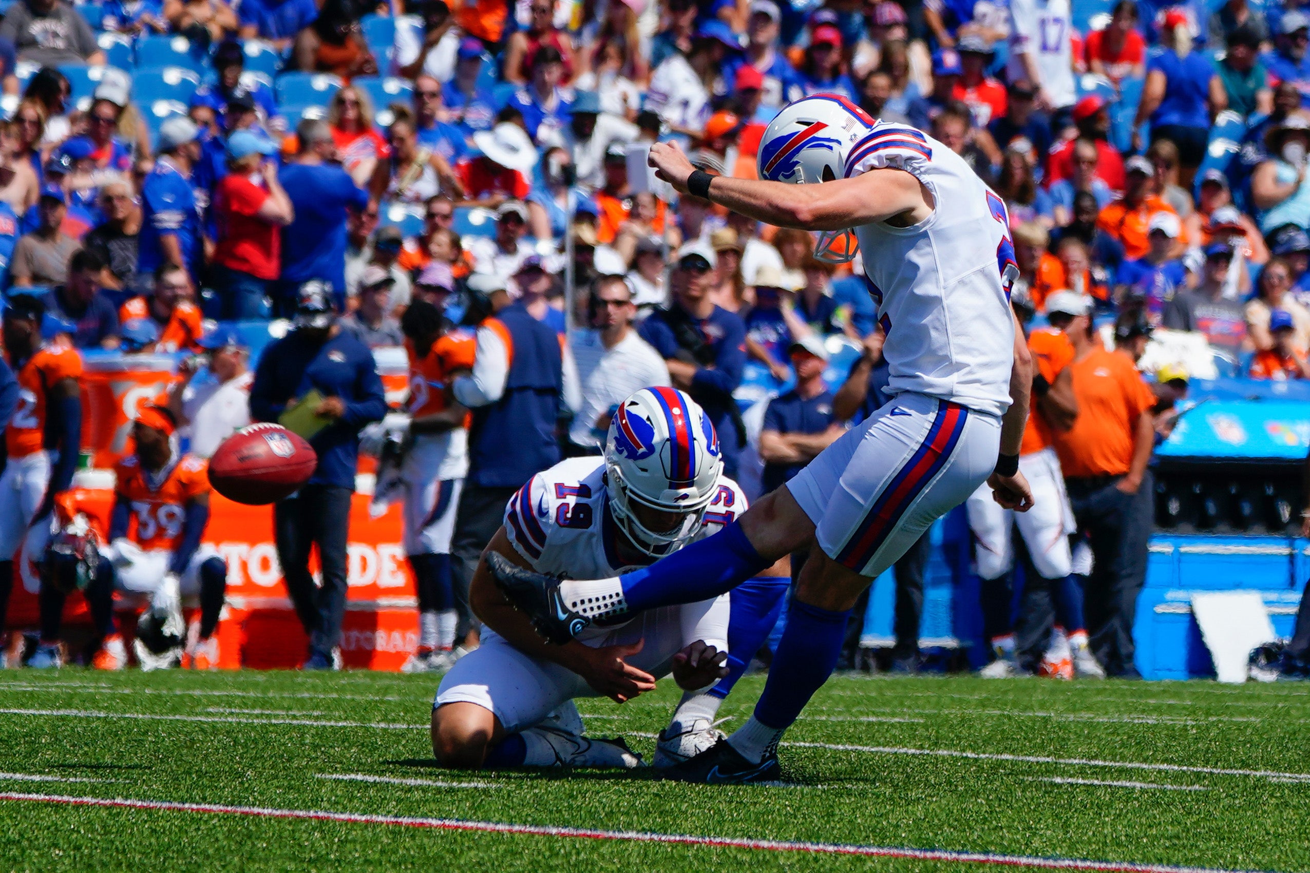 Aug 20, 2022; Orchard Park, New York, USA; Buffalo Bills place kicker Tyler Bass (2) kicks an extra point with Buffalo Bills punter Matt Araiza (19) holding during the first half at Highmark Stadium
