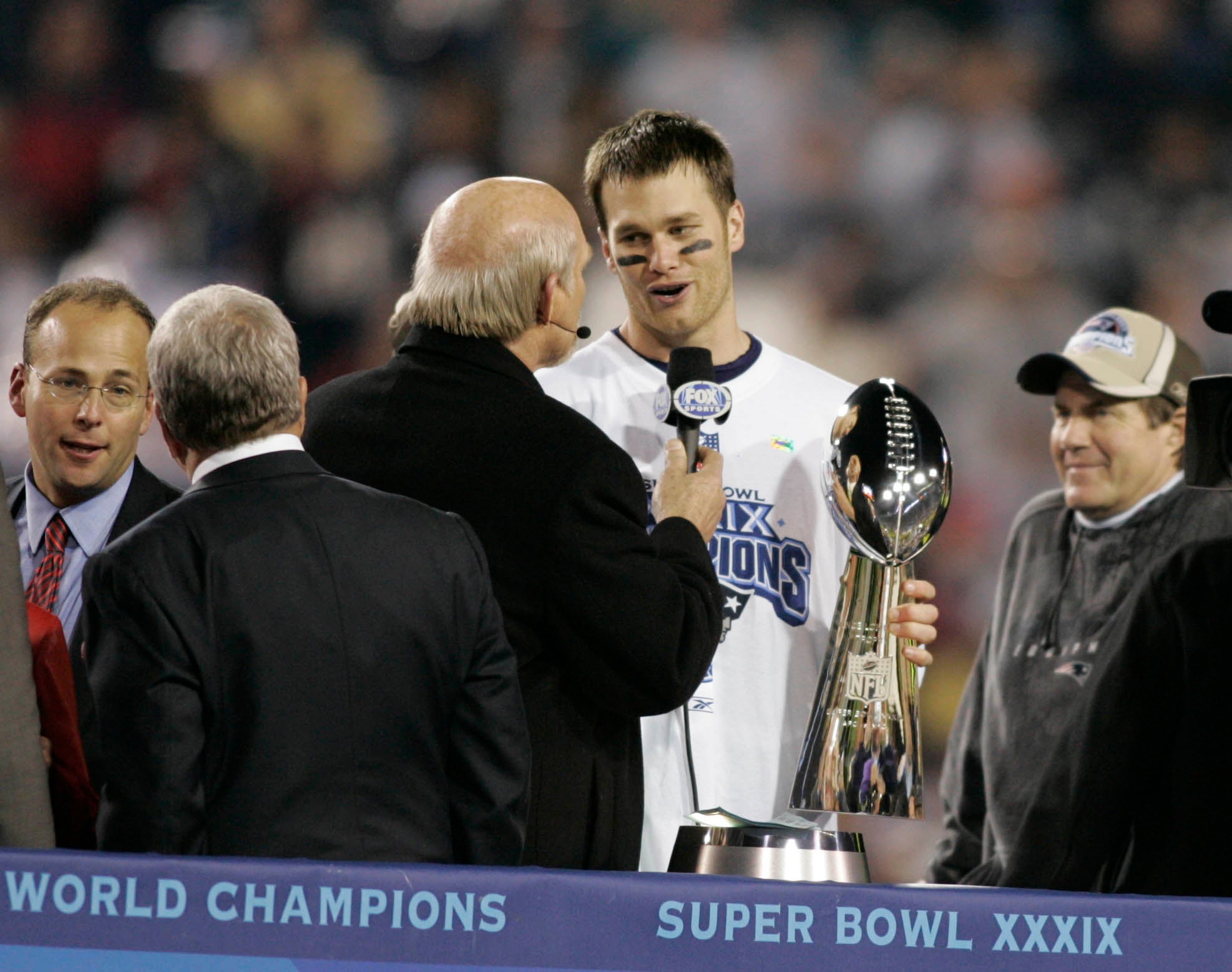 Feb 06, 2005; Jacksonville, FL, USA; New England Patriots quarterback Tom Brady is interviewed by Terry Bradshaw (left) after defeating the Philadelphia Eagles in Super Bowl XXXIX at Alltel Stadium. The Patriots won the game 24-21. 