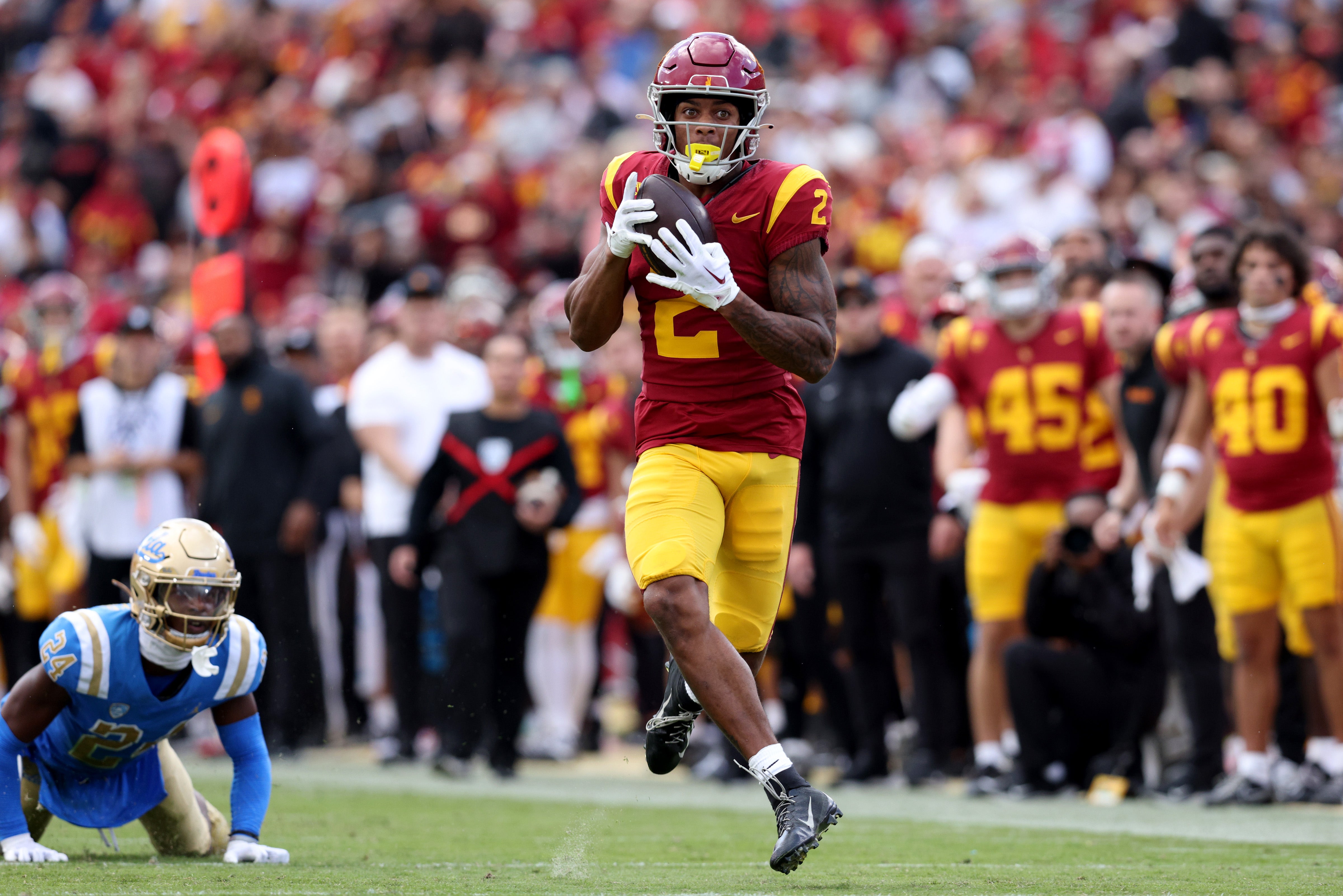 USC Trojans wide receiver Brenden Rice (2) catches a touchdown against UCLA Bruins defensive back Jaylin Davies (24) during the second quarter at United Airlines Field at Los Angeles Memorial Coliseum.