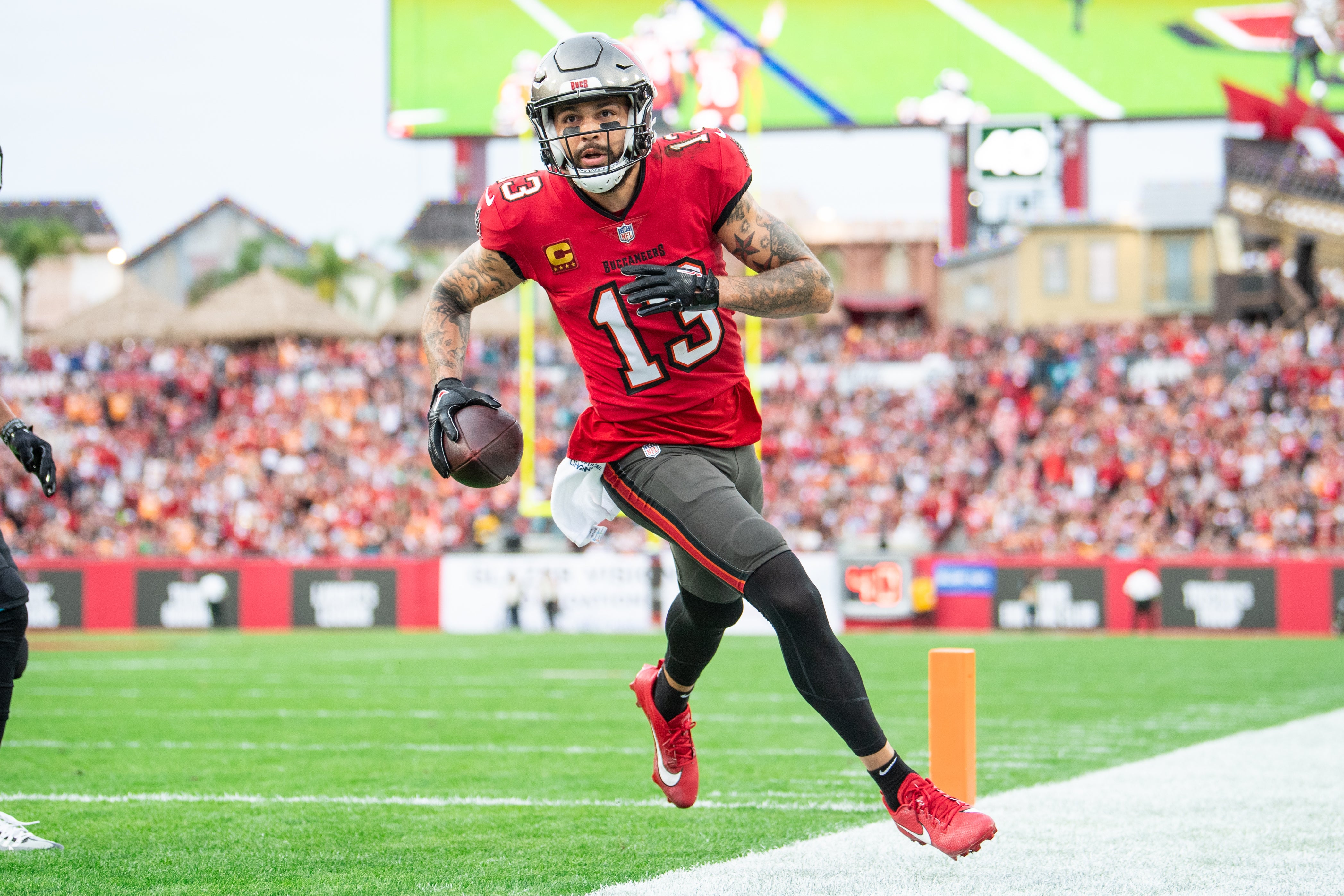 Dec 24, 2023; Tampa, Florida, USA;Tampa Bay Buccaneers wide receiver Mike Evans (13) catches the touchdown against the Jacksonville Jaguars in the second quarter at Raymond James Stadium.