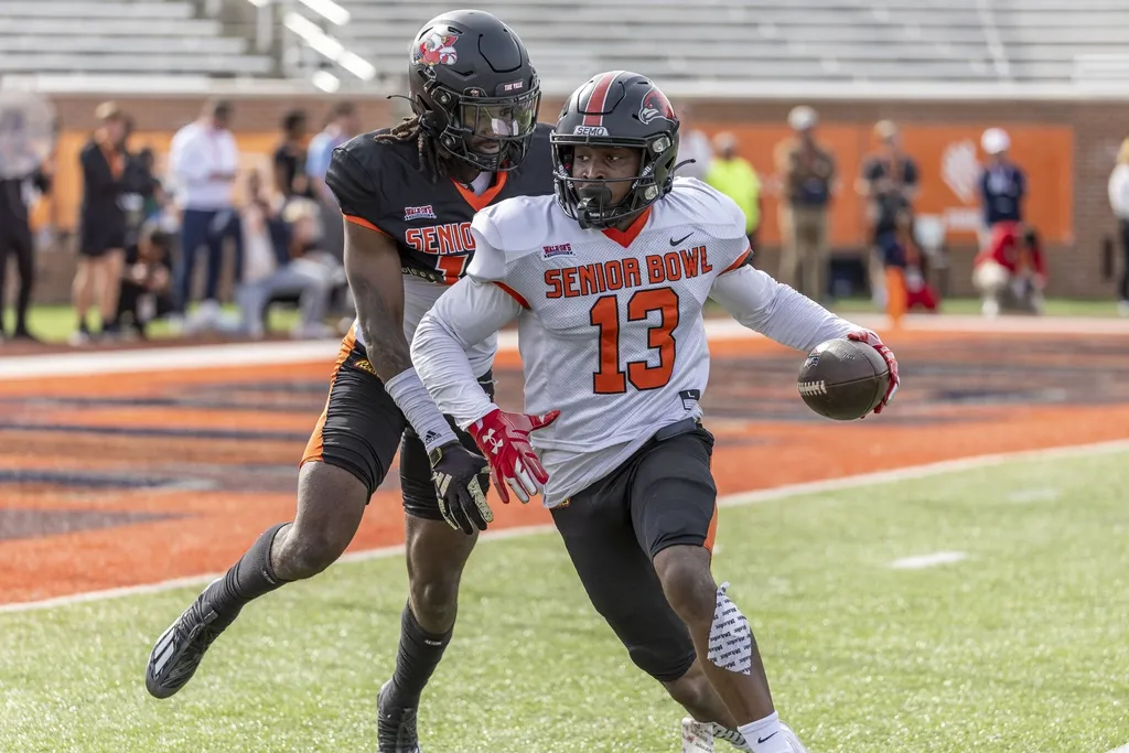American wide receiver Ryan Flournoy of Southeast Missouri (13) turns to the end zone after a pass catch against American defensive back Jarvis Brownlee Jr of Louisville (19) during practice.